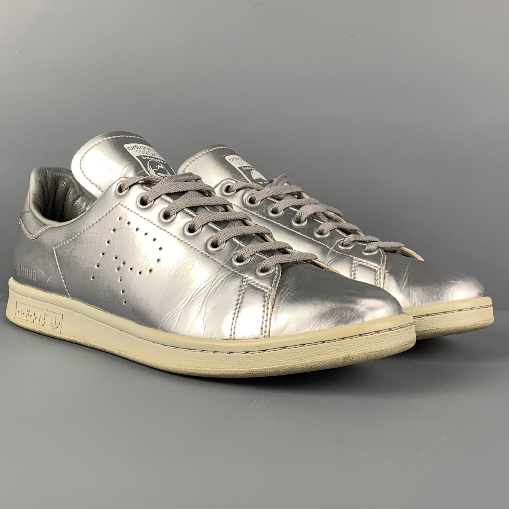 RAF SIMONS x ADIDAS sneakers comes in a grey metallic leather featuring a low-top style anda lace up closure. 

Very Good Pre-Owned Condition. Light wear.
Marked: 10

Outsole: 12 in. x 4 in. 