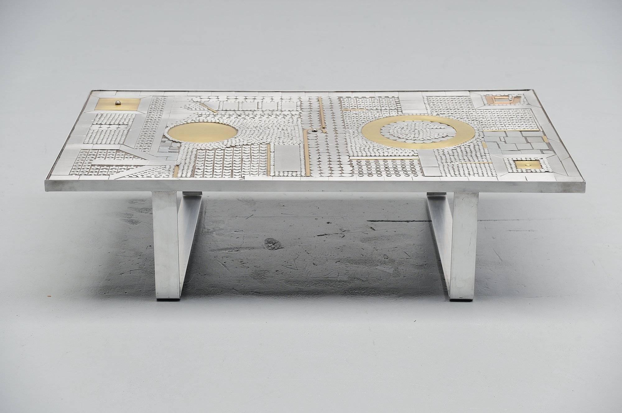 Fantastic crafted coffee table designed by Raf Verjans, manufactured in his own atelier in Belgium, 1970. This table has a steel frame and is completely inlayed with aluminum and brass parts which gives a great look. Raf Verjans can be scaled