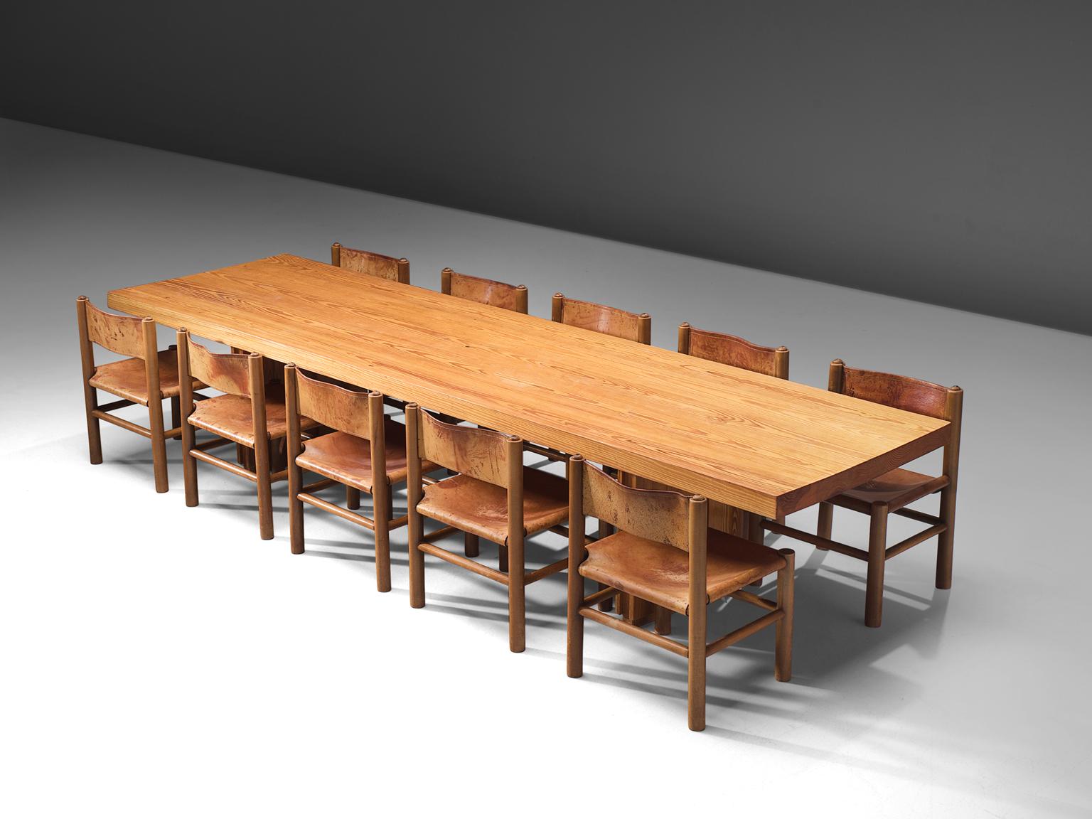 Rafael De La Joya, pine table and cognac leather and pine chairs, Spain, 1960s.

This low, large table is accompanied by eleven chairs which have the same legs, is made in solid pine. The dining table presents the beautiful patterns of the pine