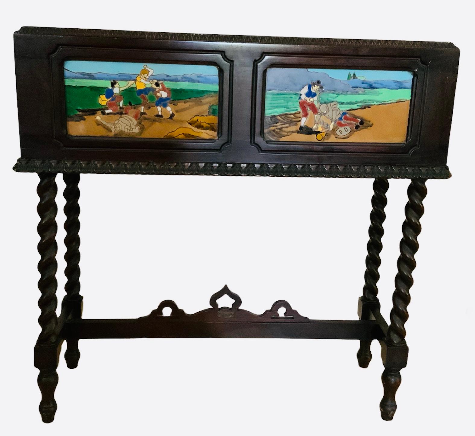 This is a rectangular shaped wood planter/jardiniere with inside metal liner. The wood background is painted black and decorated with hand painted tiles with scenes of the famous book of Miguel de Cervantes, Don Quixote. The planter is supported by