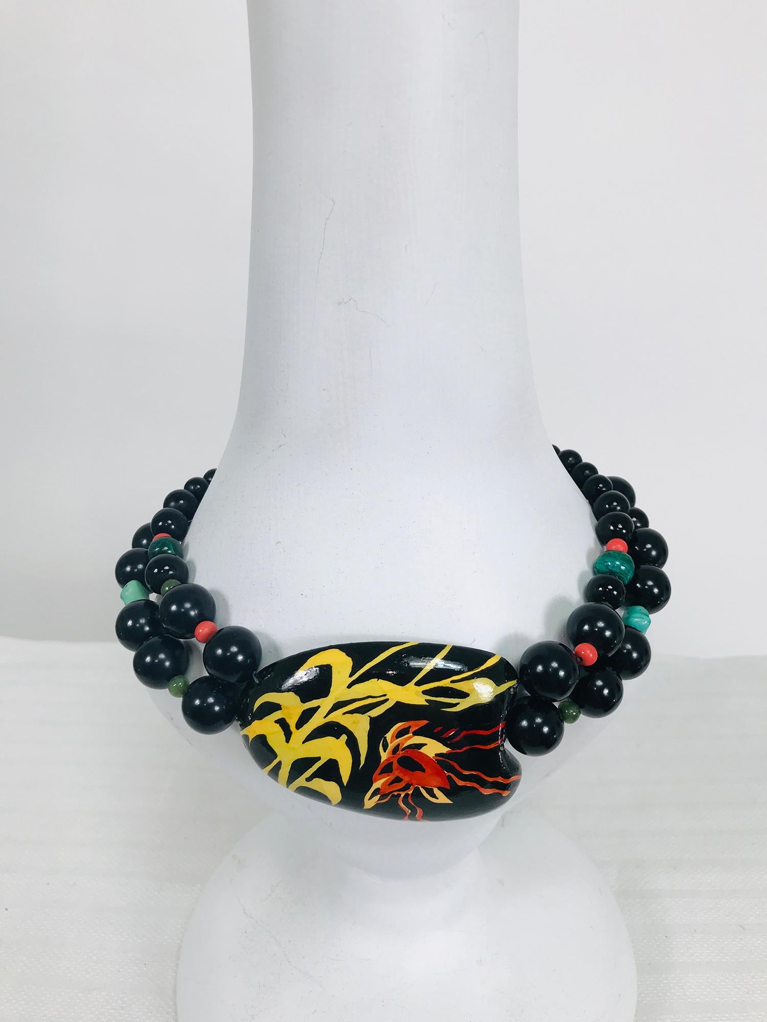 Rafael Sanchez hand painted coconut shell choker necklace with beads and a clasp marked silver from the 1980s. Black lacquer coconut shell cut in an abstract shape is painted with tropical fronds. 
Measurements are in inches
Length end to end 17 1/2