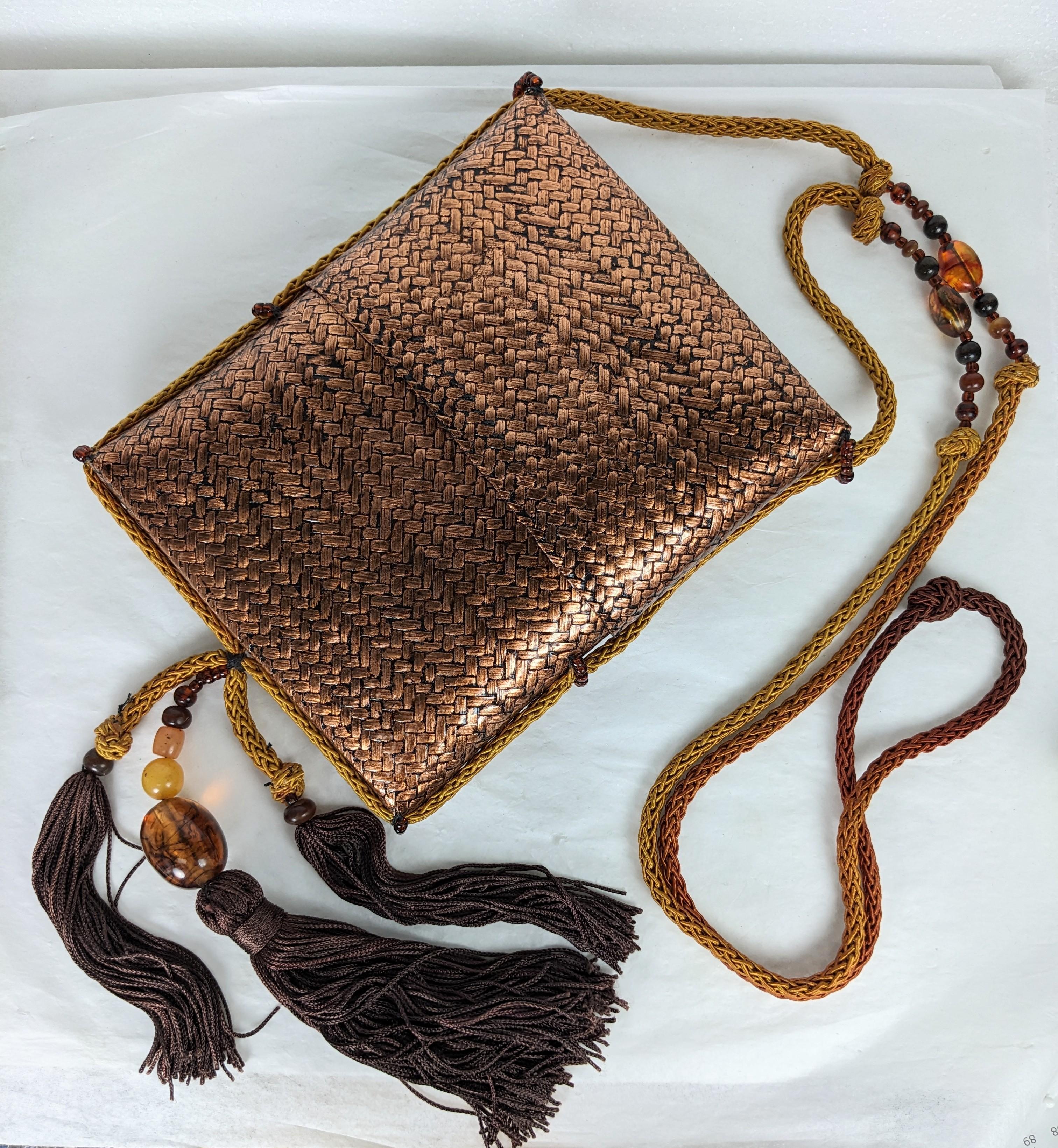Rafael Sanchez Minaudiere of copper leaf woven rattan with elaborate tassel and bead decoration from the 1970's.  Asian overtones with the ombre, braided silk cording mixed with resin and faux amber stone beads. Special Disco era day/evening novelty