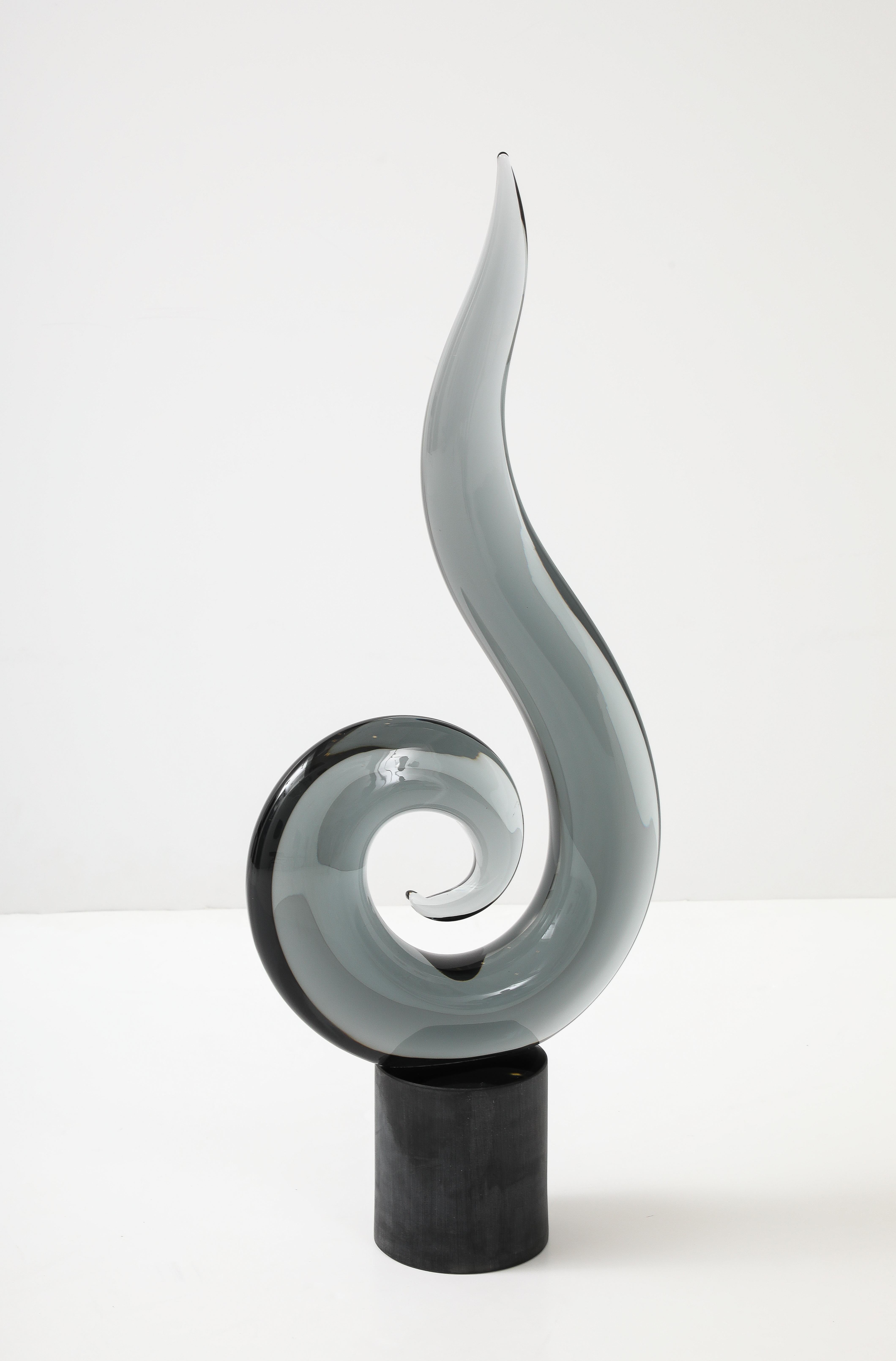 Modernist  large scale smokey grey Murano glass sculpture. The abstracted spiral is made from a thick murano glass which sis set upon a solid glass pedestal. Signed