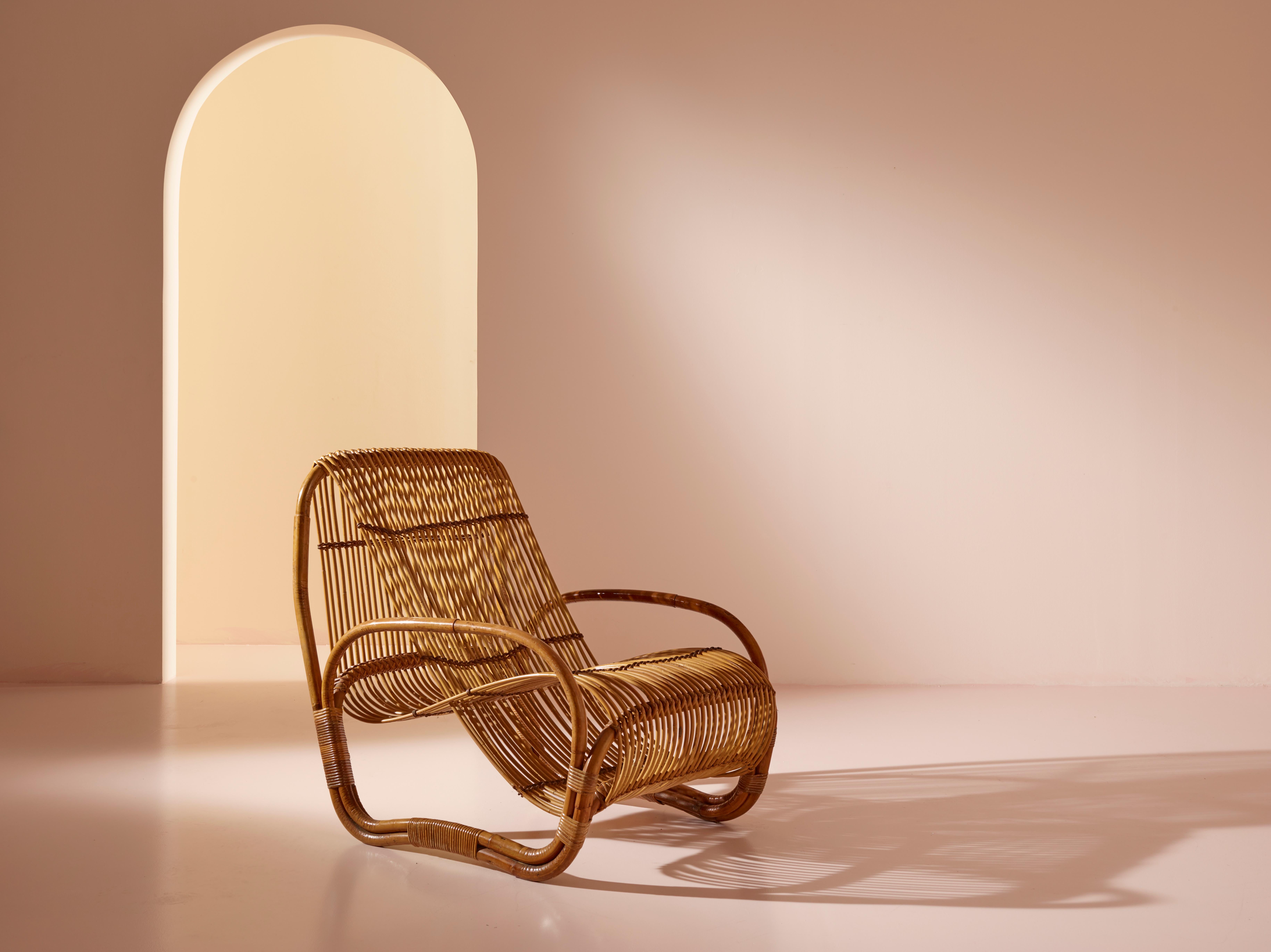 An elegant lounge chair manufactured in Italy during the 1960s. Crafted with bamboo, its design is attributed to Raffaella Crespi, showcasing organic lines that beautifully mimic an infinity loop when viewed from the side.

In very good vintage