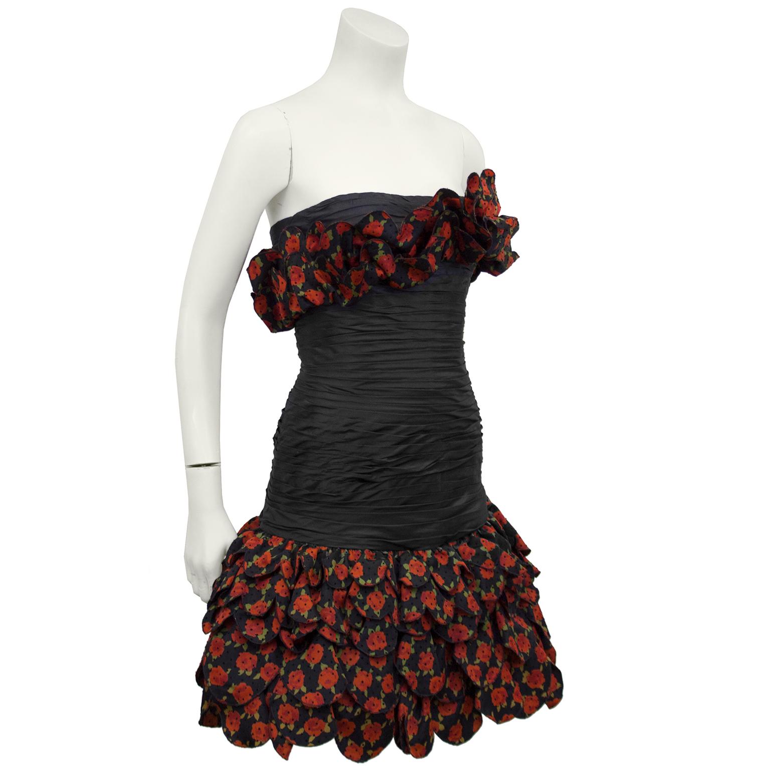 Fun 1980s Raffaella Curiel strapless, drop waist cocktail dress. Black ruched bodice with scalloped rose printed layered skirt and bust detail. Small black cut velvet polka dots add an extra layer of detail to the rose print fabric. Invisible zipper