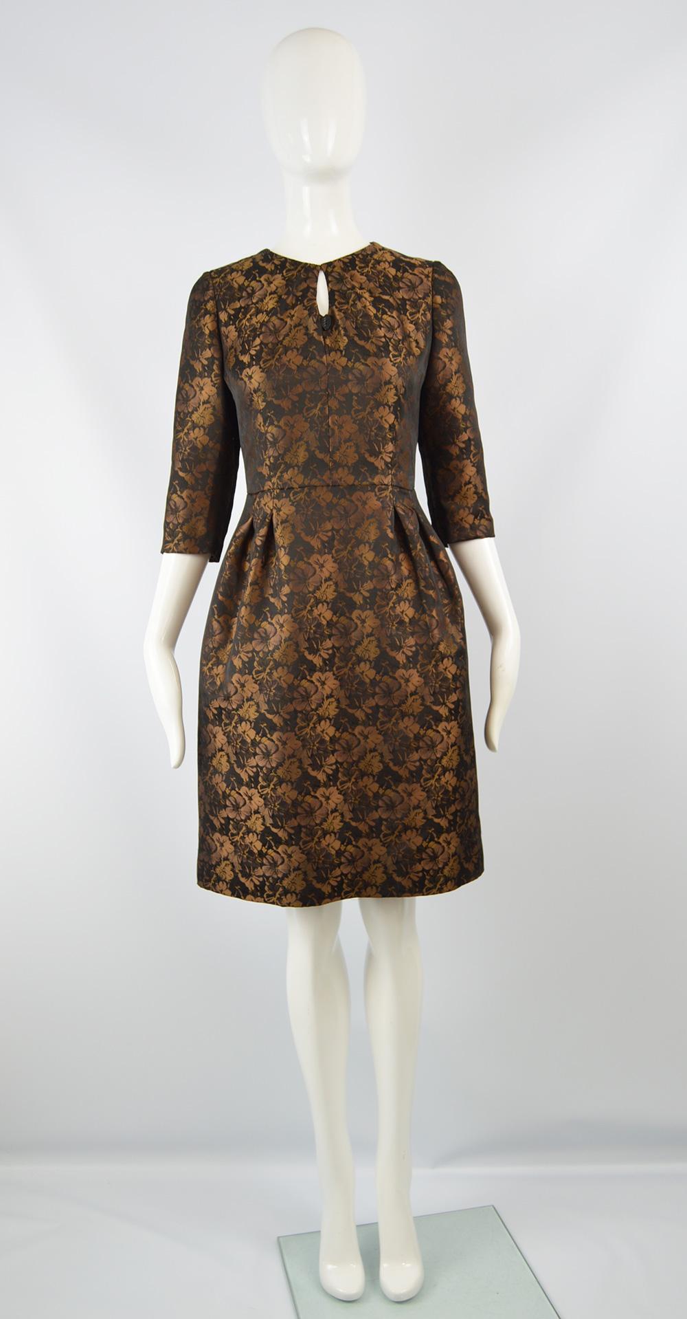 Raffaella Curiel Couture Black & Bronze Floral Jacquard Evening Dress, 1980s

Size: Unlabelled; fits like a UK 10/ US 6/ EU 38. Please check measurements.  
Bust - 34” / 86cm
Waist - 29” / 73cm
Hips - 44” / 112cm
Length (Shoulder to Hem) - 36” /