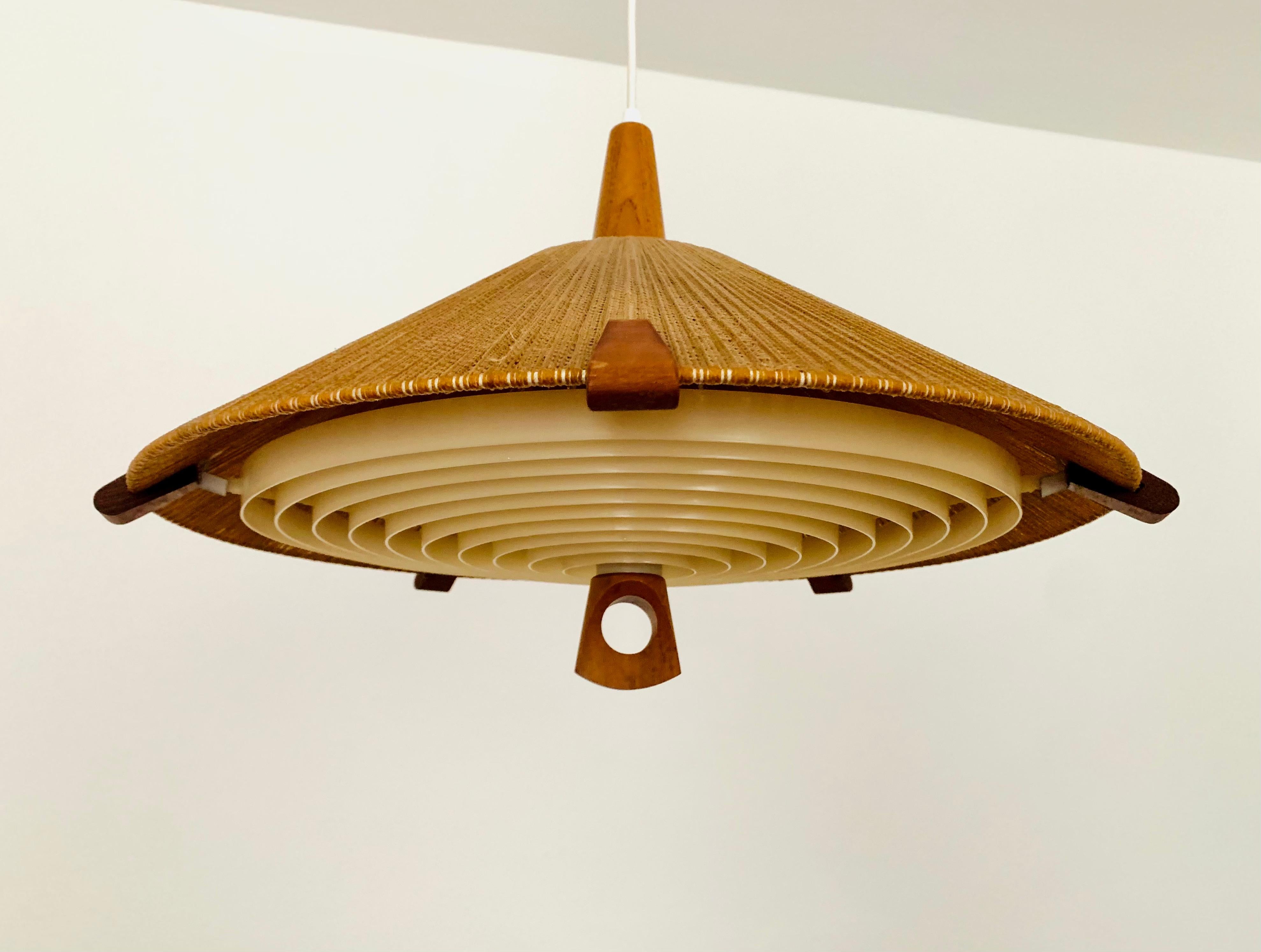 Exceptionally beautiful and very rare pendant light from the 1960s.
The design is very unusual.
The shape and the materials create a warm and very pleasant light.
Particularly beautiful teak details.

Manufacturer: Temde

Condition:

Very