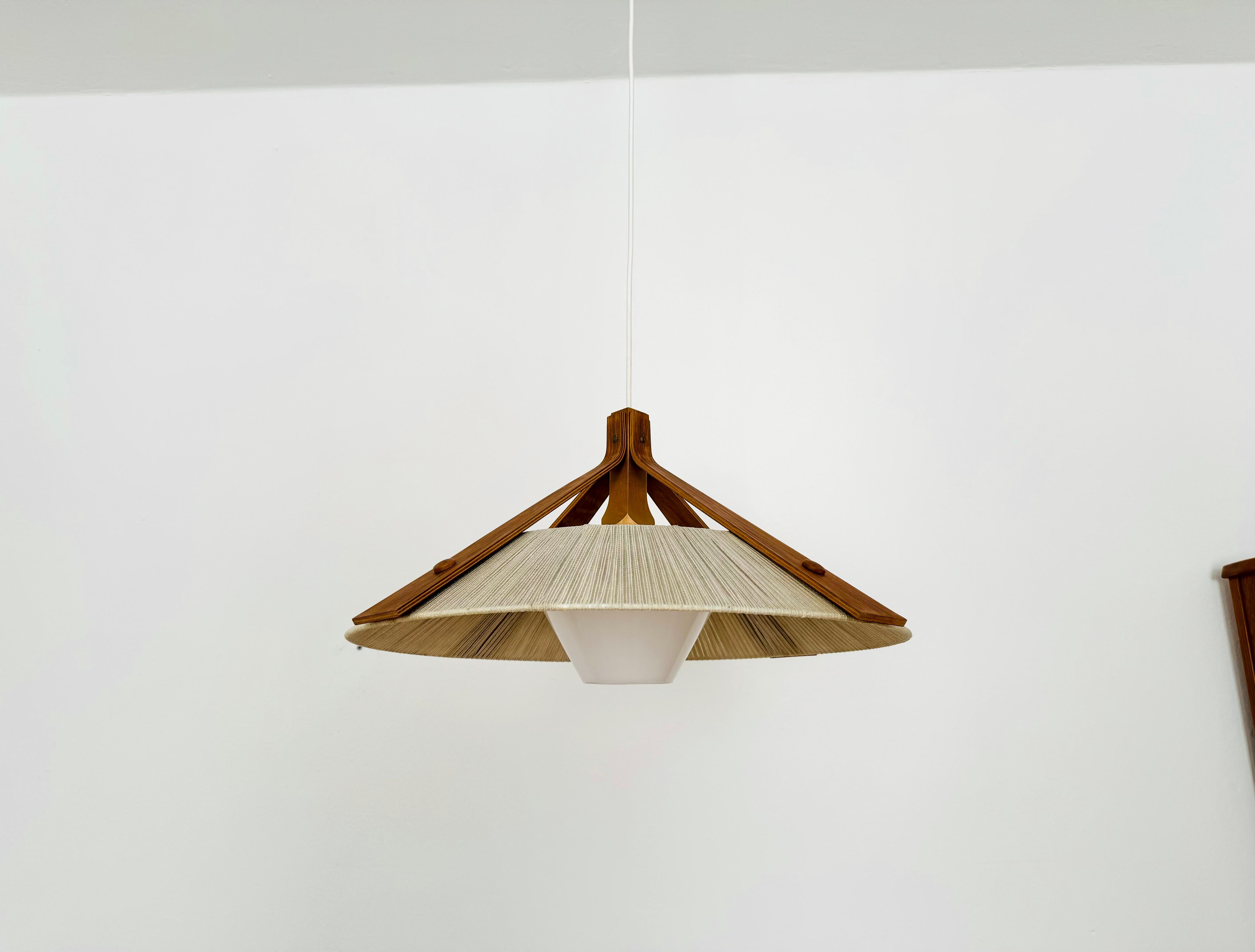 Exceptionally beautiful and large pendant lamp from the 1960s.
The design is very unusual.
The shape and materials create a warm and very pleasant light.

Condition:

Good vintage condition with signs of wear consistent with age.
The raffia