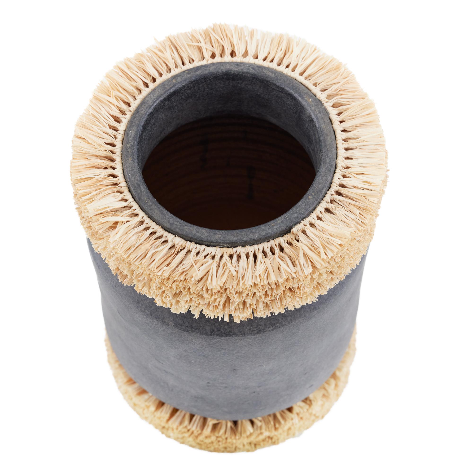 Raffie Vase – Brimming with textural richness and artisanal charm, this distinctive vase takes its design inspiration from traditional thatched roofing, bringing a sense of global influence and craftsmanship to any interior. The vessel’s form is