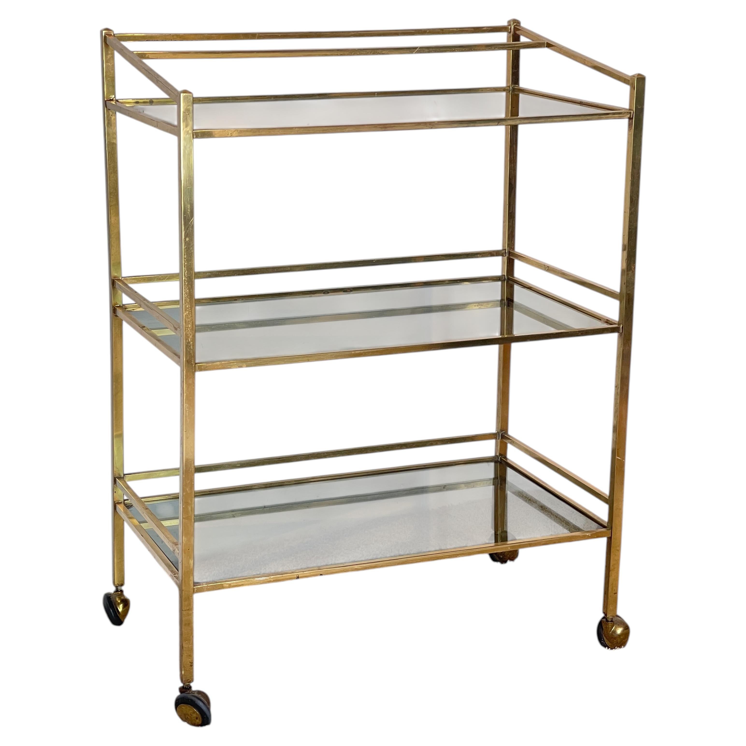 Elegant brass and glass bar cart with three shelves, from the 1970s For Sale