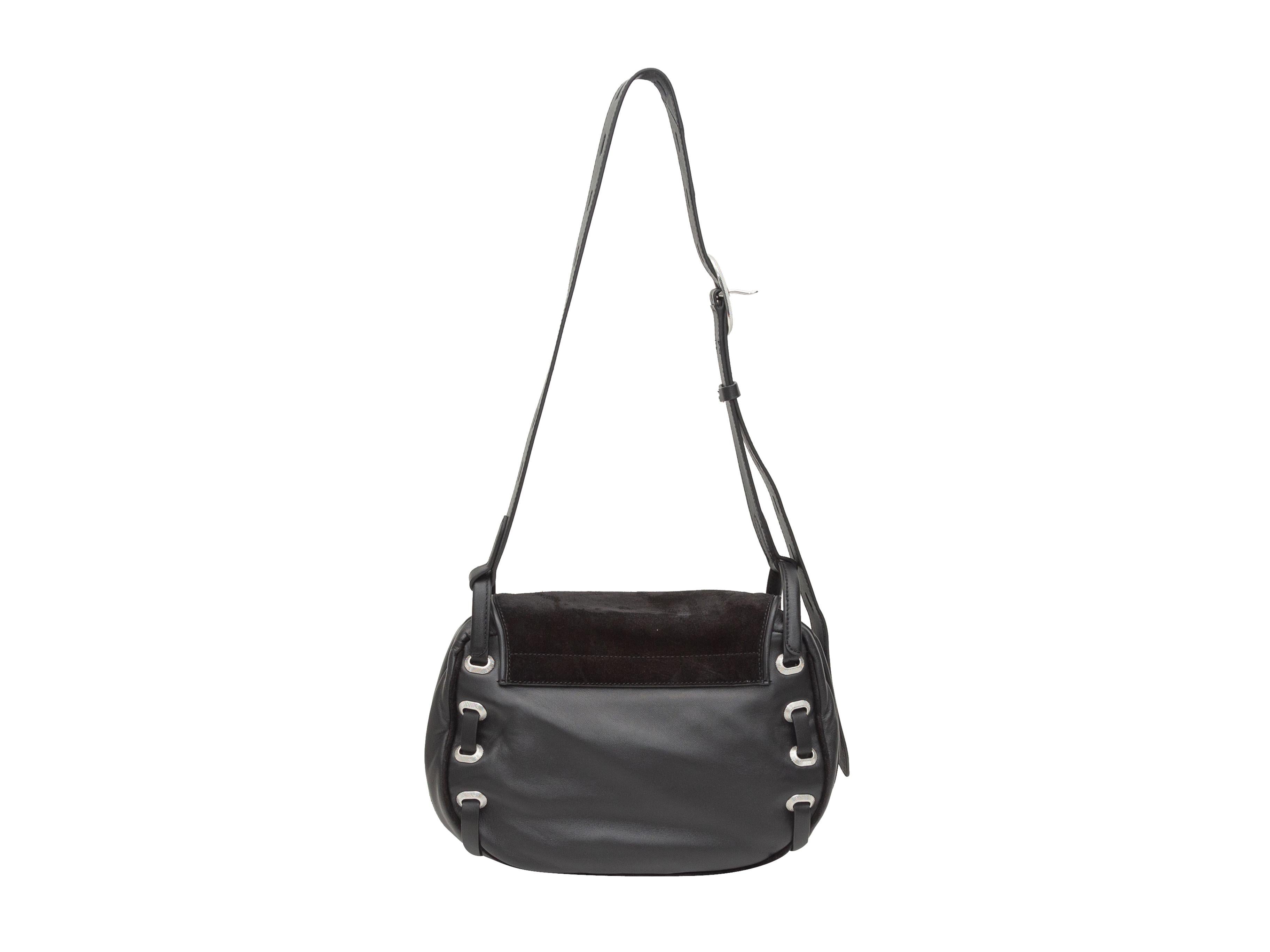 Product details: Black leather and suede Legend Saddle crossbody bag by Rag & Bone. Silver-tone hardware. Interior zip pocket. Adjustable shoulder strap. Front flap closure. 11