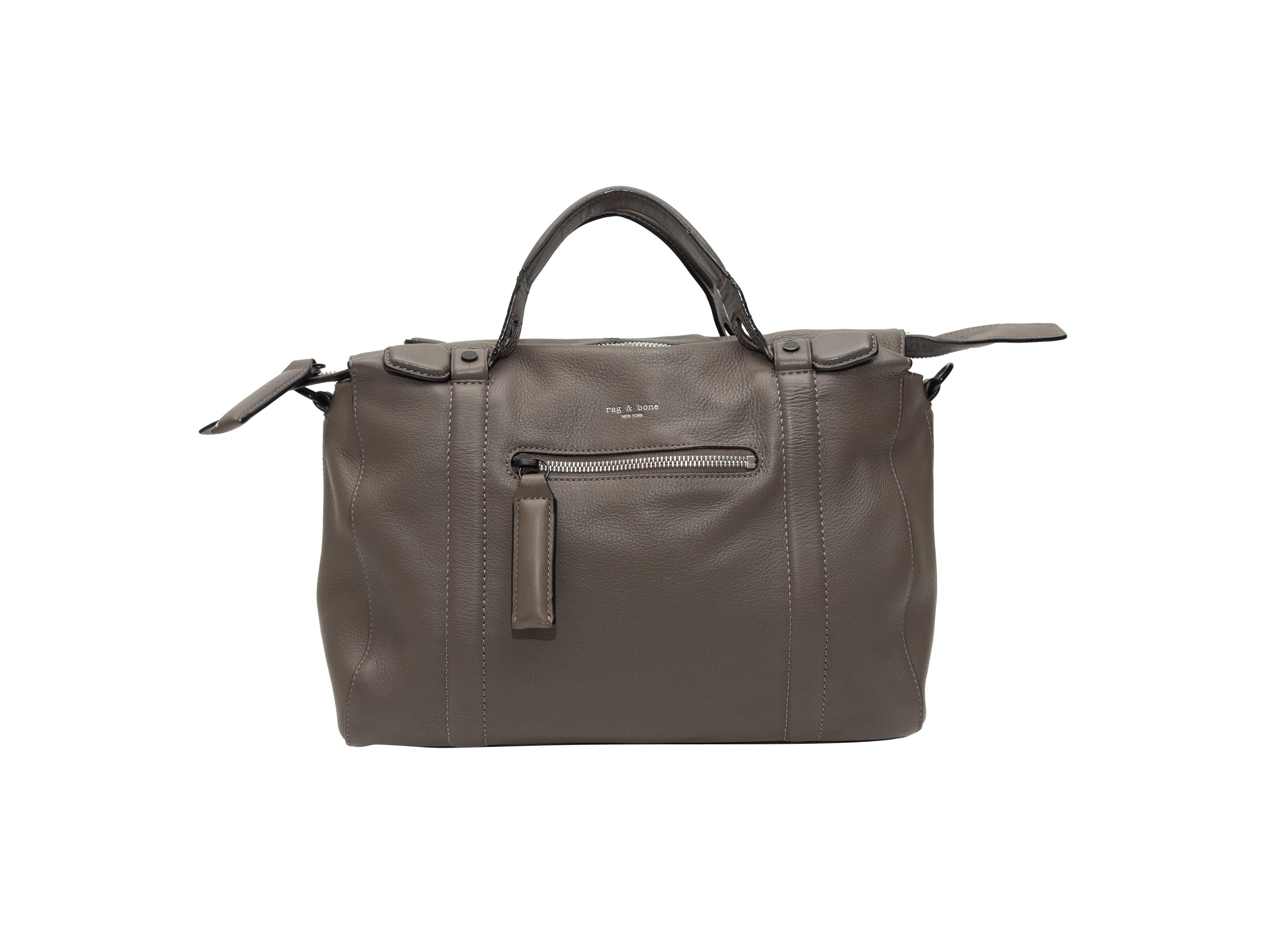Product details: Grey leather handbag by Rag & Bone. Zip pocket at exterior front. Dual top handles. Detachable shoulder strap. Zip closure at top. 12.5