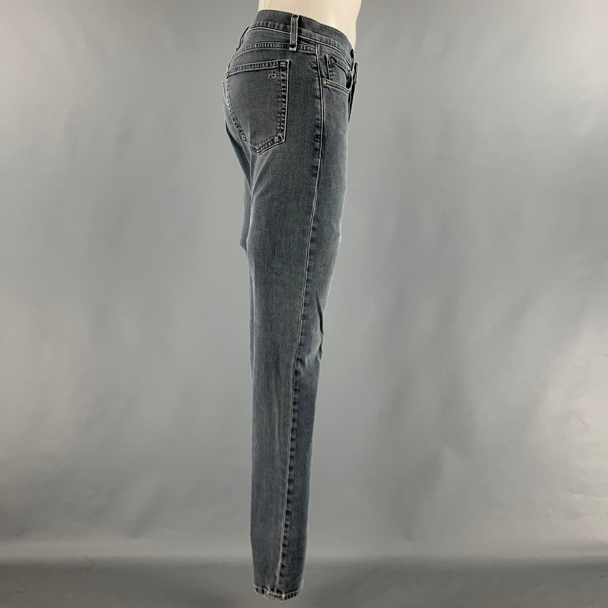 RAG & BONE jeans comes in a grey cotton polyurethane denim material featuring a supper slim fit and a button fly closure. Very Good Pre-Owned Condition. 

Marked:   31 

Measurements: 
Waist: 32 inches Rise: 8.5 inches Inseam: 33 inches  
  
  
