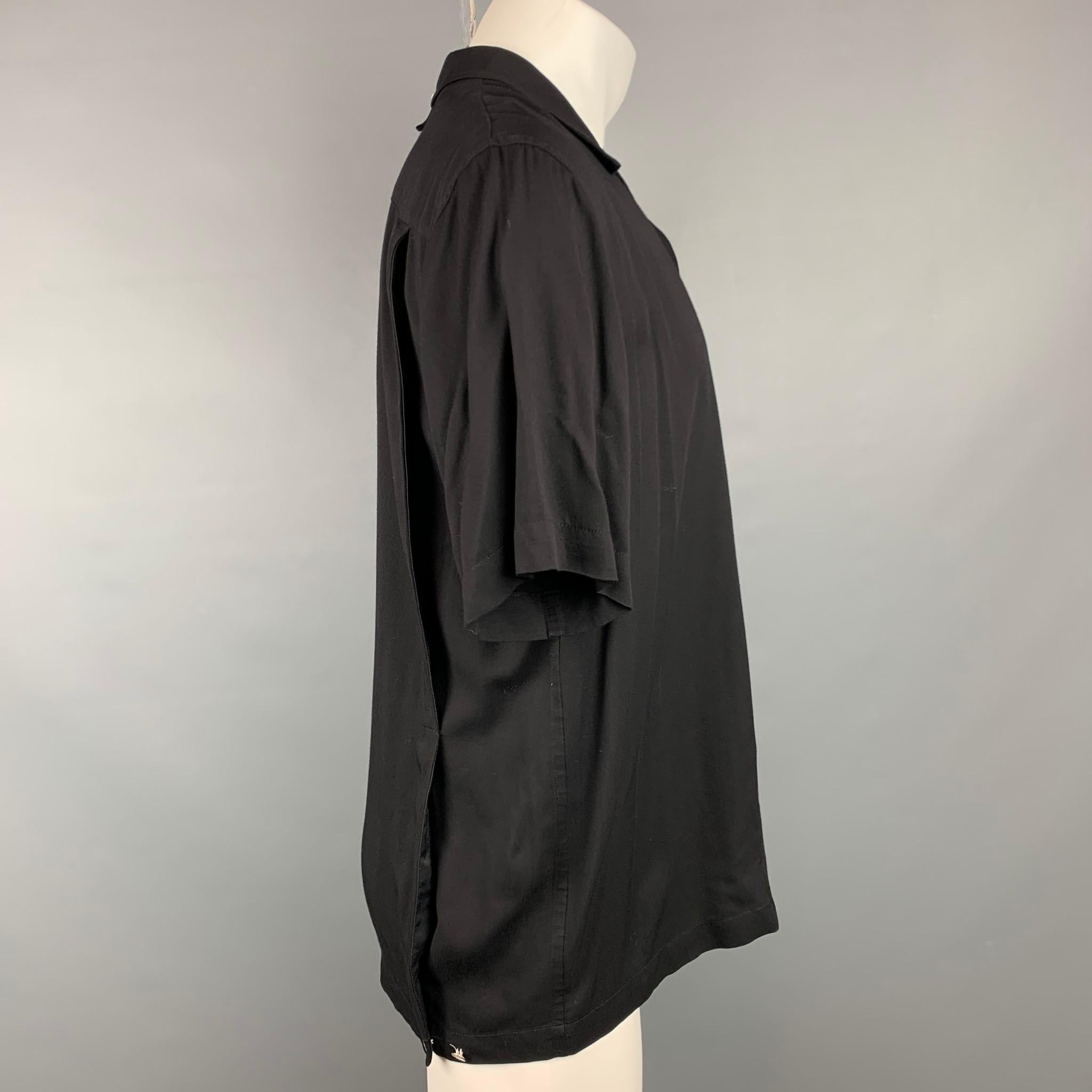 RAG & BONE short sleeve shirt comes in a black viscose featuring a camp collar style, back button details, patch pocket, and a buttoned closure.

Very Good Pre-Owned Condition.
Marked: M

Measurements:

Shoulder: 19 in.
Chest: 46 in.
Sleeve: 10.5