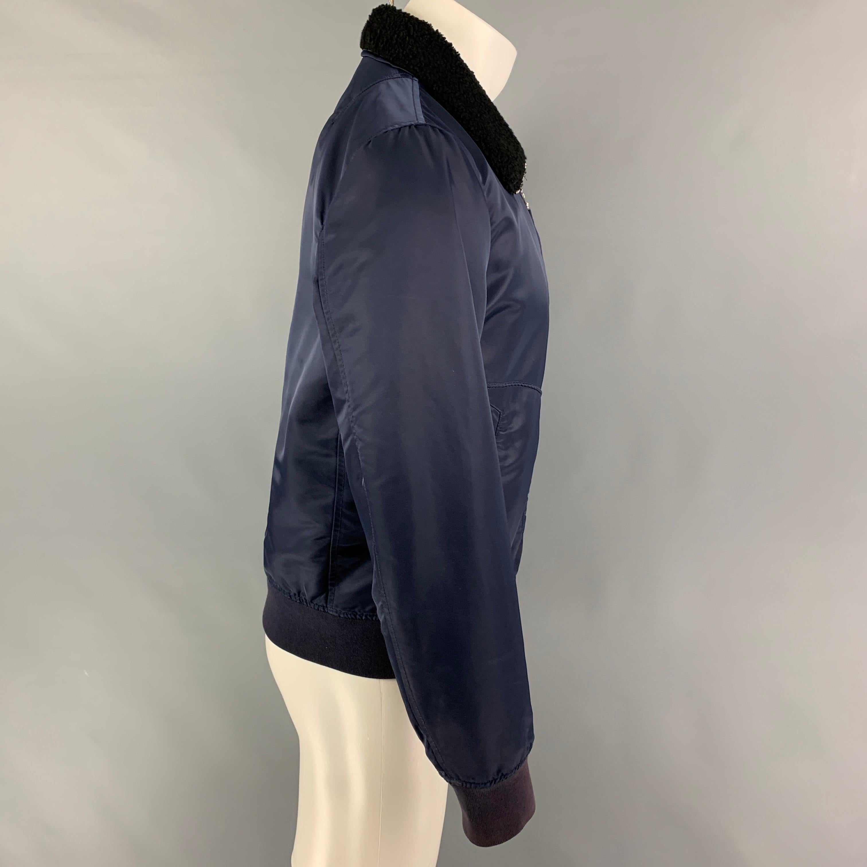RAG & BONE jacket comes in a navy nylon with a orange interior featuring a bomber style, shearling lamb collar, ribbed hem, slit pockets, and a full zip up closure. 

Very Good Pre-Owned Condition.
Marked: M

Measurements:

Shoulder: 17.5 in.
Chest: