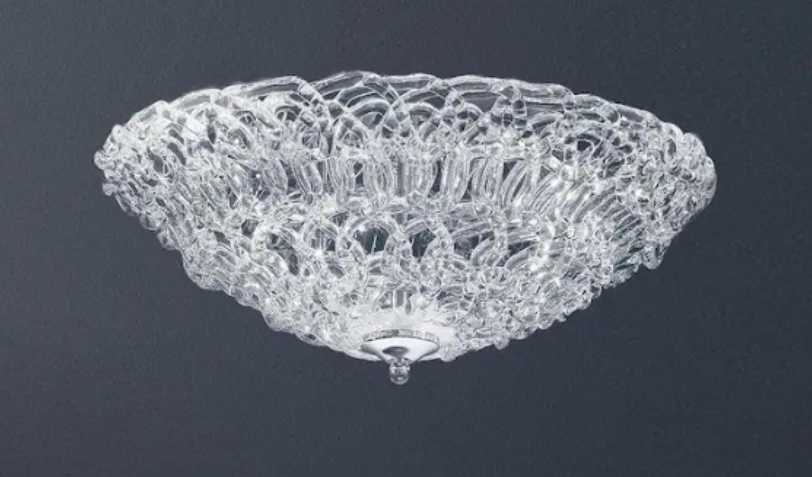 Italian flush mount with clear Murano glasses hand blown to form an organic cobweb texture, mounted on chrome finish frame / Made in Italy
3 lights / G9 type / max 40W each
Measures: Diameter 19 inches / height 5 inches
Order only / This item ships