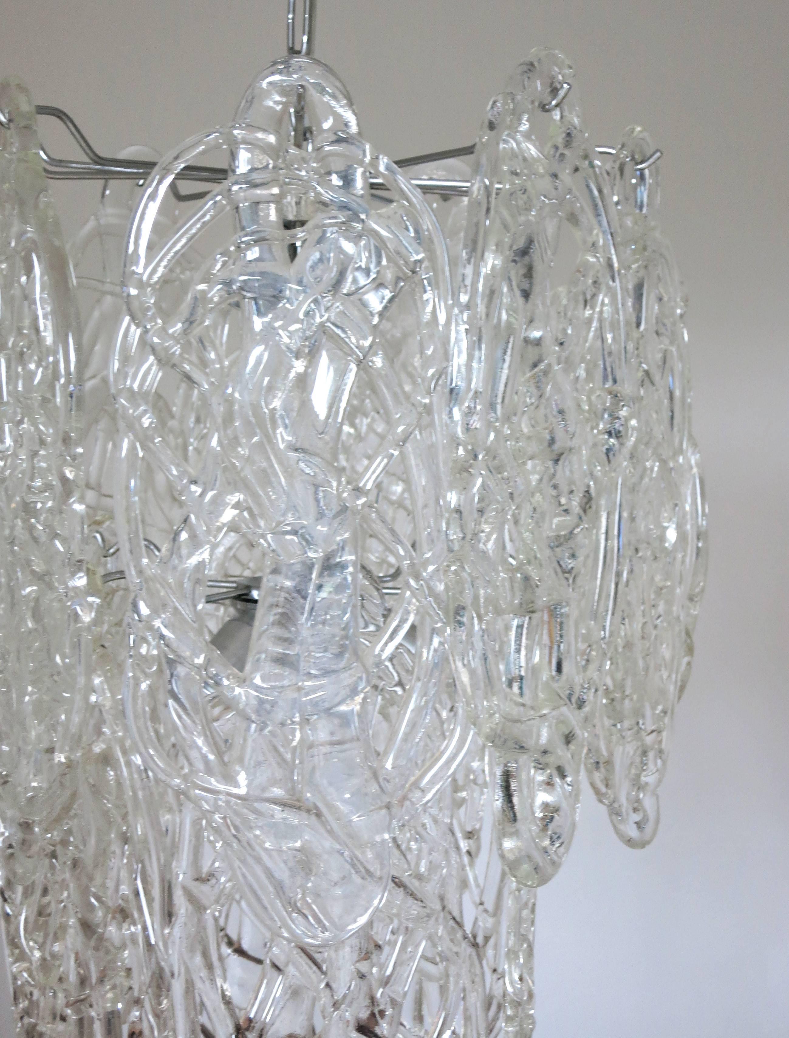 Original vintage Italian chandelier with clear Murano glass blown in intricate cobweb-like pattern, mounted on chrome metal frame / Designed by Vistosi circa 1960’s / Made in Italy 
7 lights / E12 or E14 type / max 40W each
Diameter: 16 inches /