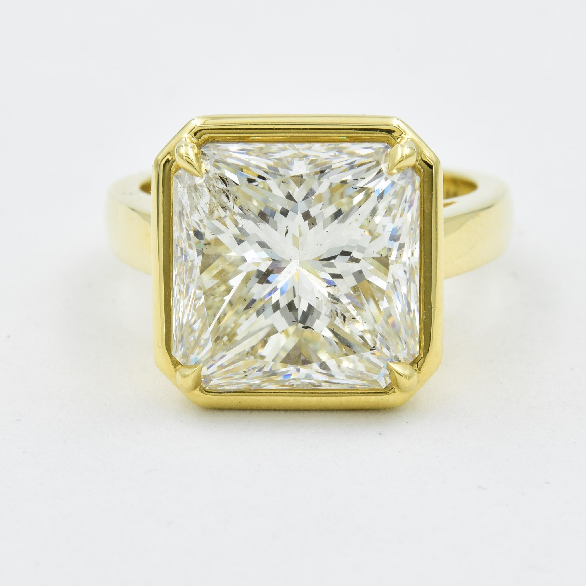 This stunning engagement ring hosts a 9.17 carat Radiant cut diamond in an 18k yellow gold mount with a bezel style setting.  The diamond has a beautiful light performance and has been certified by GIA.  The mounting works perfectly for this diamond