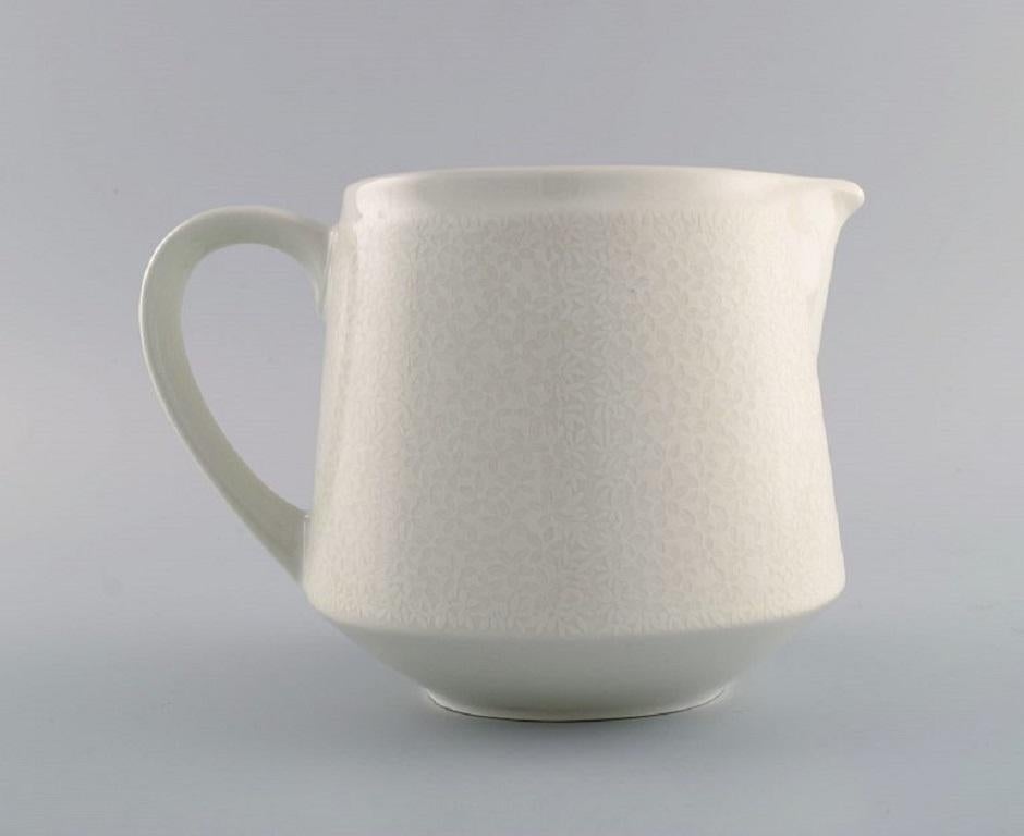 Scandinavian Modern Raija Uosikkinen for Arabia. Pitsi porcelain jug with floral decoration. For Sale