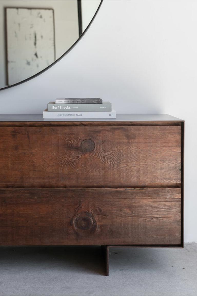 This dresser is custom made in Los Angeles. Industrial steel casing is sheered to size and attached to a substrate, then patinated antique bronze. Wood is cut to size and joined to drawer face. Four drawers with soft close slides. 

Reclaimed wood