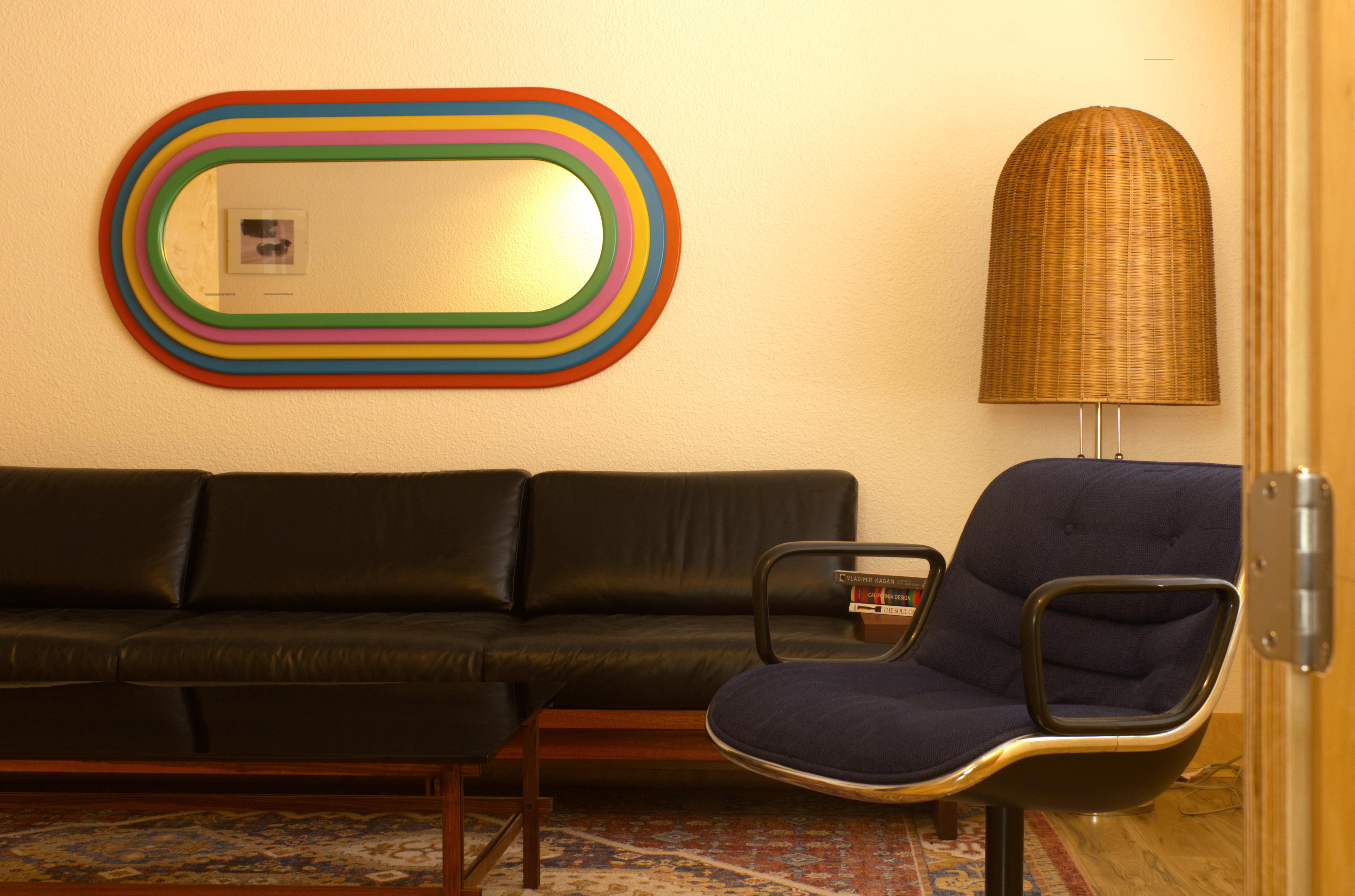 This mirror is part of the Ultra-Rainbowla mirror series by American furniture maker Greg Palombo. The mirror is inspired by Ettore Sottsass and the Memphis Milano Movement and the belief that objects can express far more than just function. They