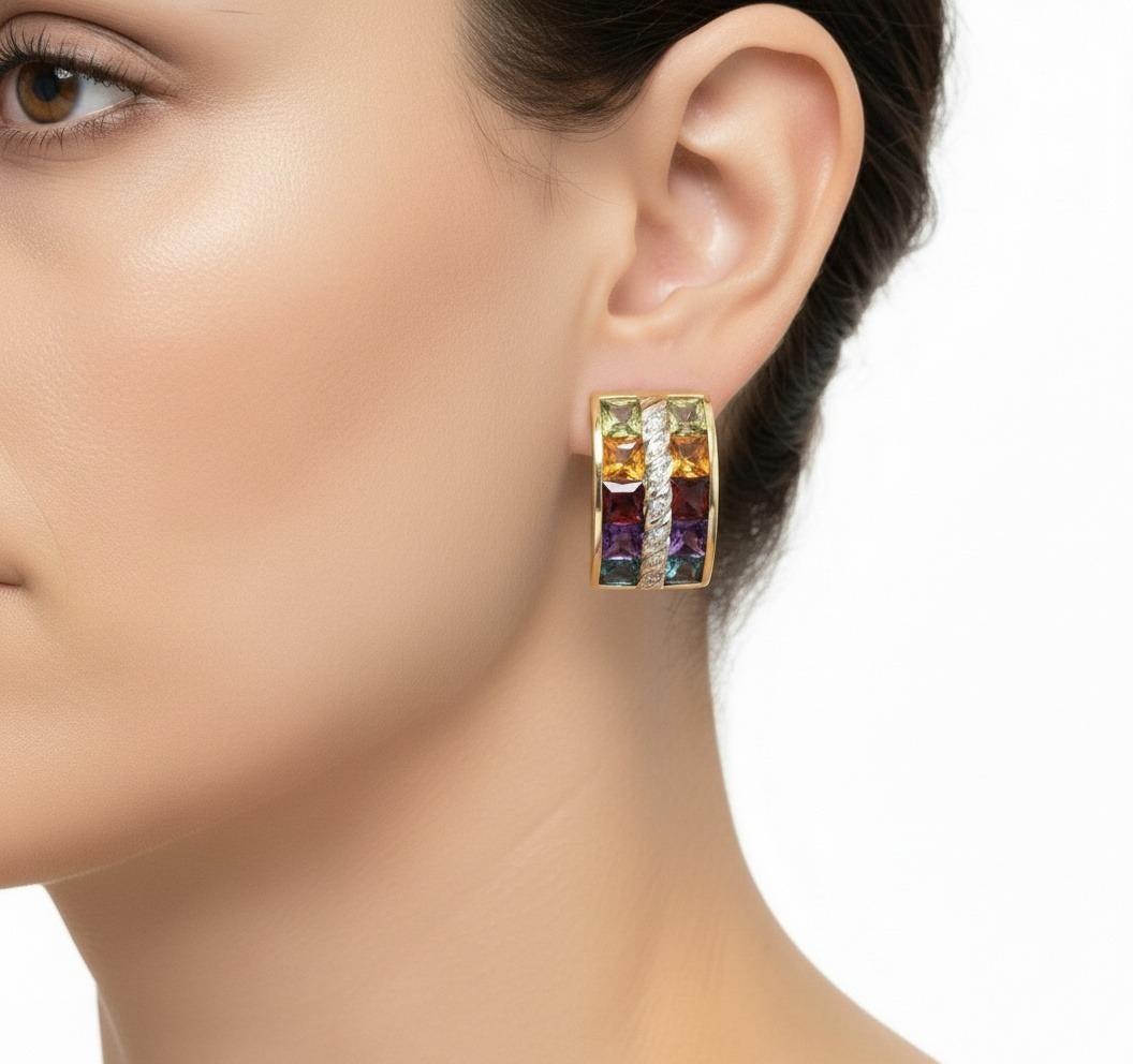 Este vibrante par de pendientes de aro exhibe la belleza de las gemas naturales, expertamente elaboradas en lustroso oro amarillo y blanco de 18 quilates y con 10 gemas multicolor de talla princesa, como topacio azul, amatista, granate, citrinos y