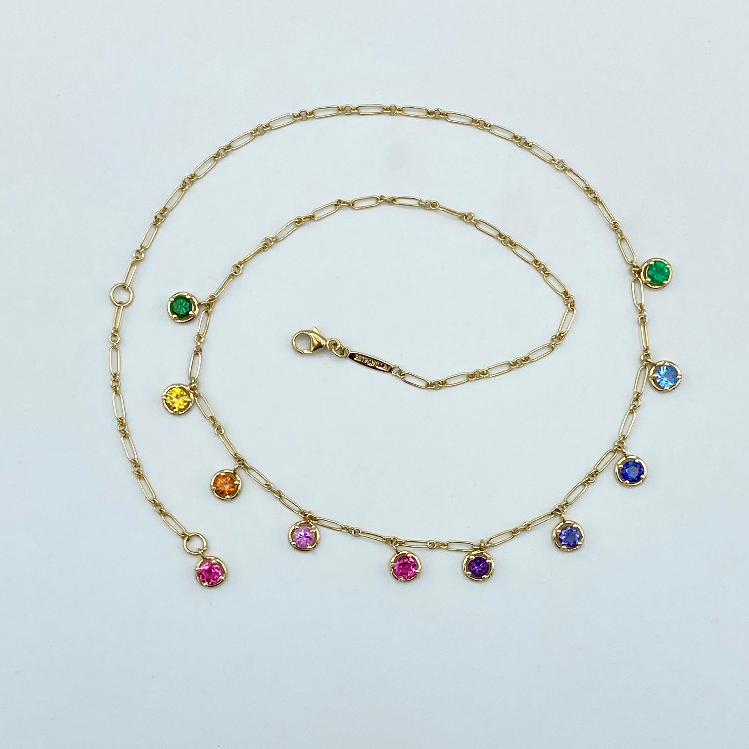 Rainbow Aquamarine Emerald Sapphire Gemstone Handmade Necklace 18 Kt Gold

This necklace is handmade in yellow gold.
I wanted to create this chain with ten precious stones of different colors scaled: from green tsavorite to emerald green through