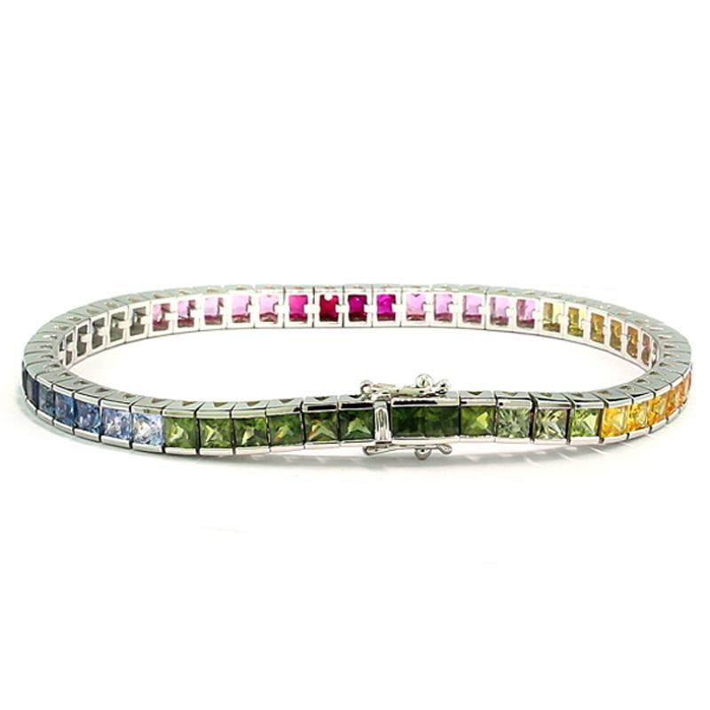 a wonderful modern bracelet made of 4 rubies and 50 sapphires, together approx. 12.50 carats. The rubies and sapphires are arranged in rainbow colors of green, yellow, orange, pink, purple-red, and blue, assembled as color segments with alternating