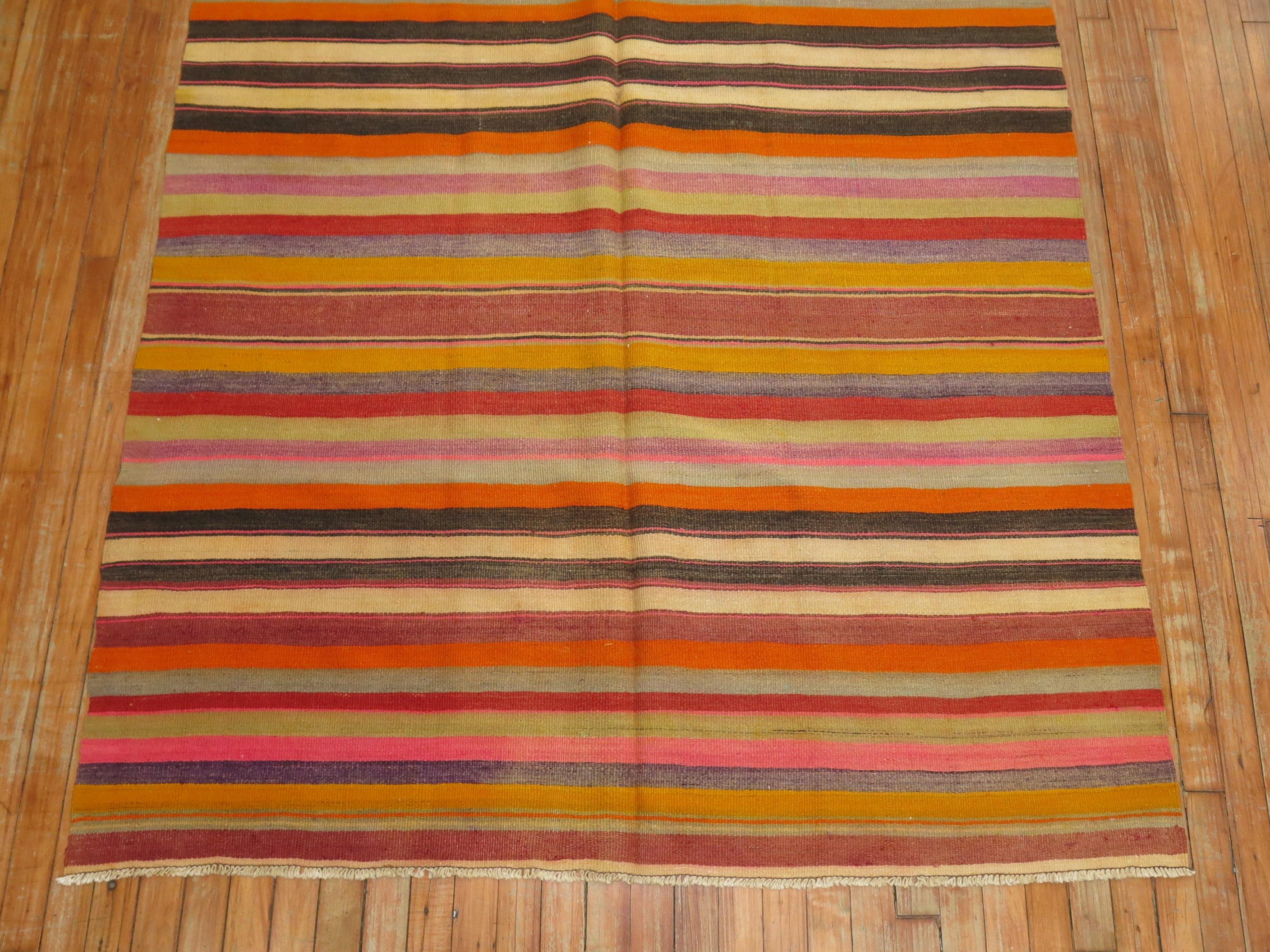 Turkish Kilim from the mid-20th century with a striped design in an array of bright colors.

Measures: 4'10'' x 8'4''.