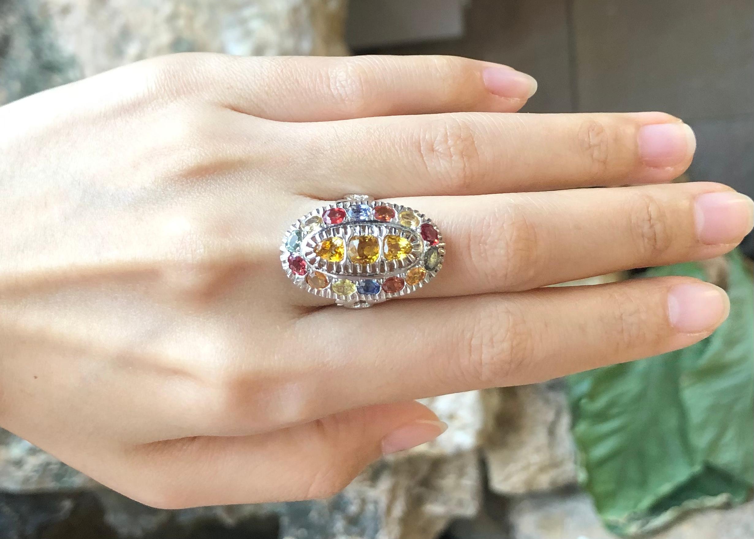 Rainbow Colour Sapphire with Cubic Zirconia Ring set in Silver Settings

Width:  1.5 cm 
Length: 2.7 cm
Ring Size: 55
Total Weight: 6.24 grams

*Please note that the silver setting is plated with rhodium to promote shine and help prevent oxidation. 