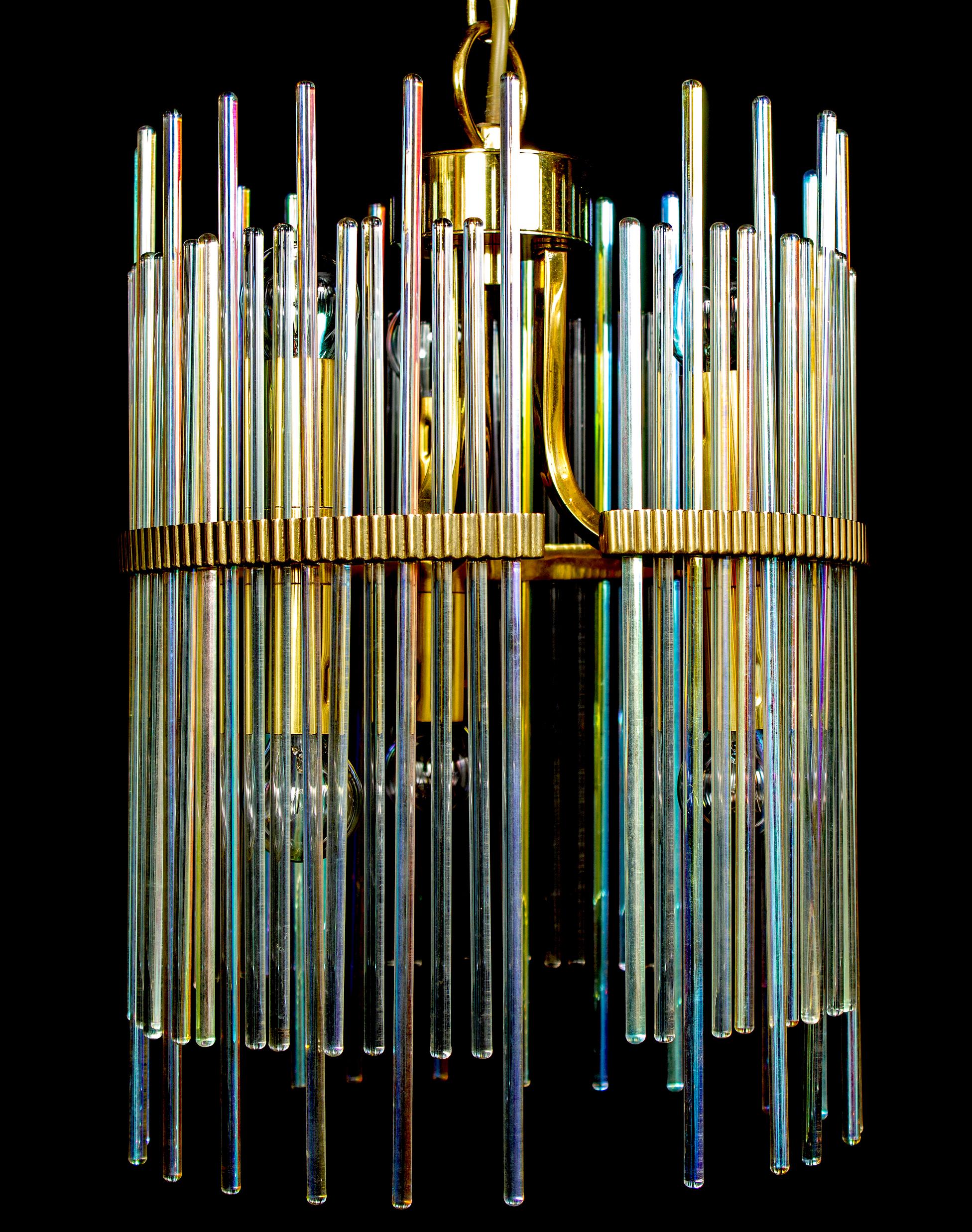 Stunning 1960s Gaetano Sciolari iridescent glass rod modernist chandeliers with brass frame. Six E 14 light bulbs.
Available also a pair of delicious table lights.
Excellent vintage condition.