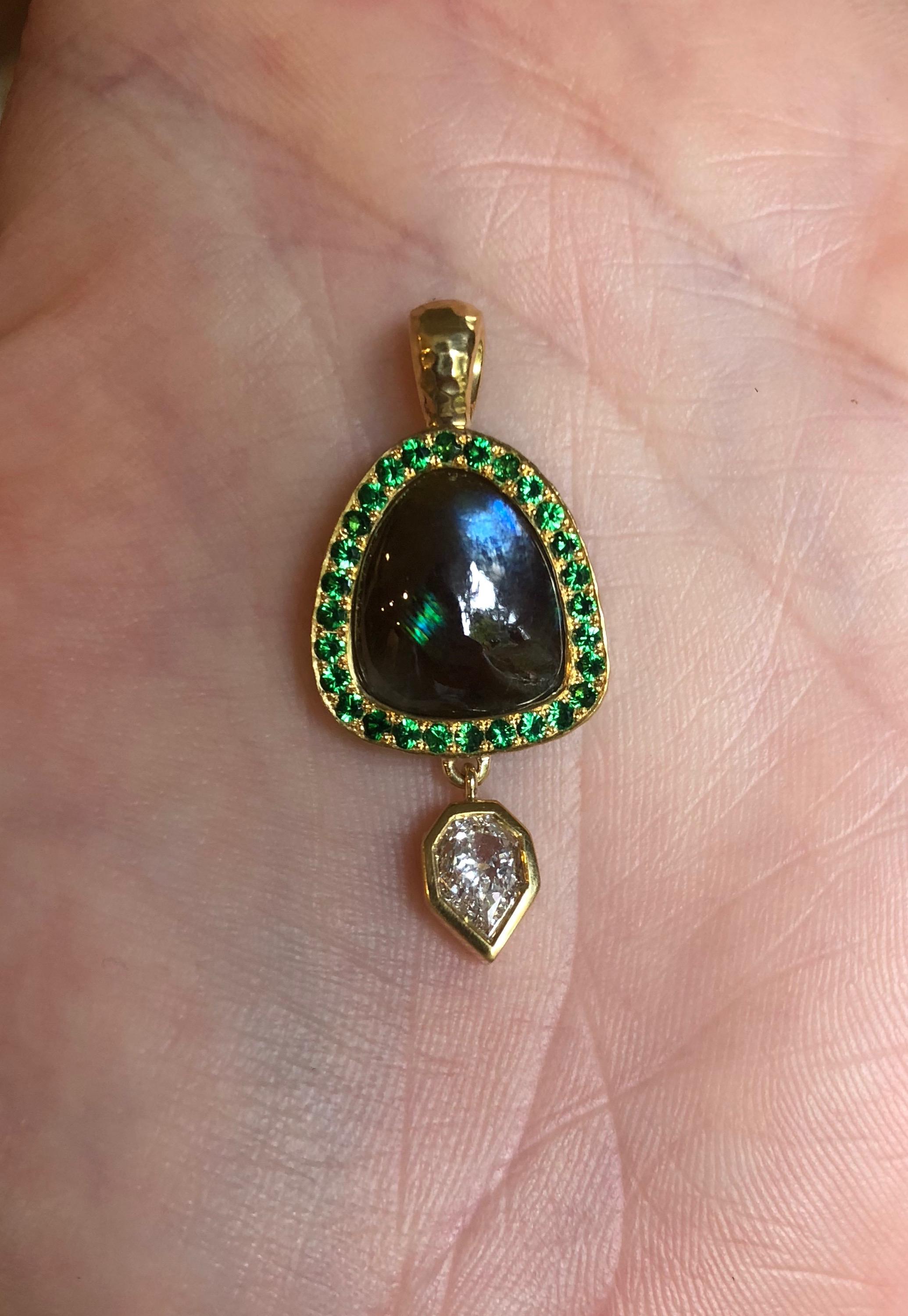 For a collector of rare gems. A vibrant display of the ultra rare iridescent Rainbow (Andradite) garnet is encircled by the finest Bridges Tsavorites, as well as a GIA certified E-VVS2 Empress cut diamond. Hand fabricated (see 