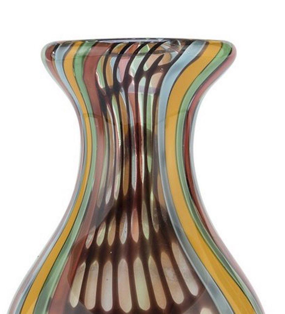 Rainbow glass vase is a very rare vase realized by Italian Manufacture in the 1970s.

A beautiful vase with vertical stripes of various colors and with a burgundy mesh band. 
Very good conditions.

This object is shipped from Italy. Under existing