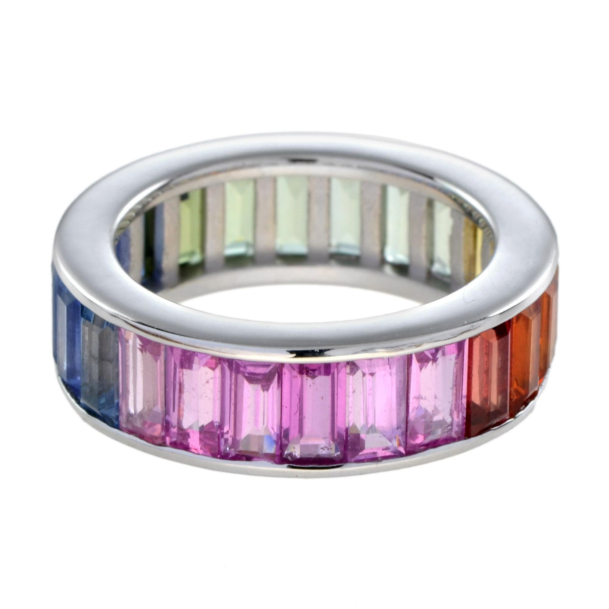 A unisex ring that can truly amp up the style of any outfit!
This rainbow sapphire eternity band is the perfect addition to your collection. Twenty-four baguette-cut rainbow sapphires are vertically set in 18K white gold. The ring measures 6 mm.
