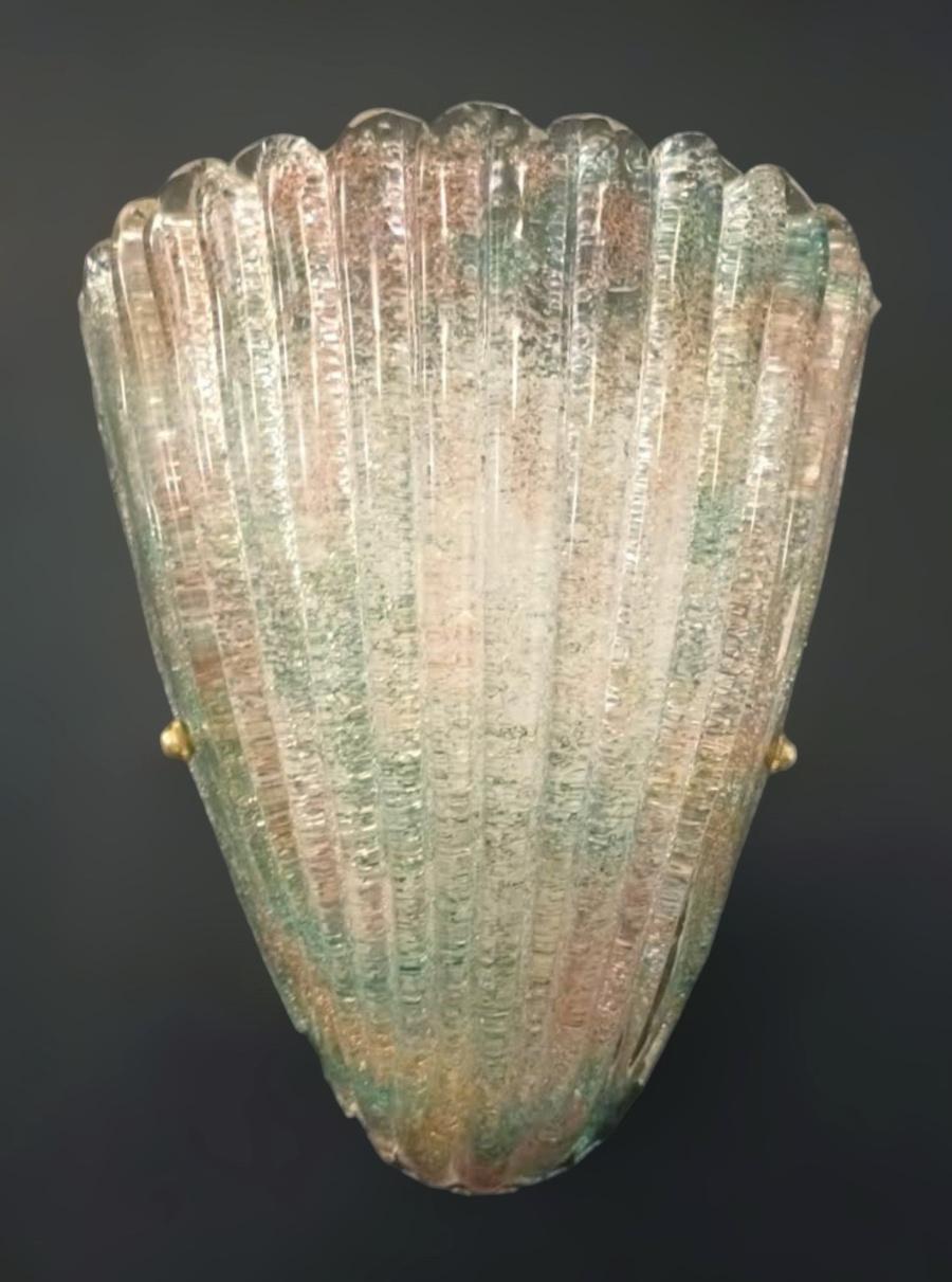 Italian wall light with textured Murano glass shield hand blown with rainbow colored Graniglia to produce granular textured effect, mounted on white metal frame / Made in Italy in the style of Barovier e Toso, circa 1960s
Measures: Height 11.5