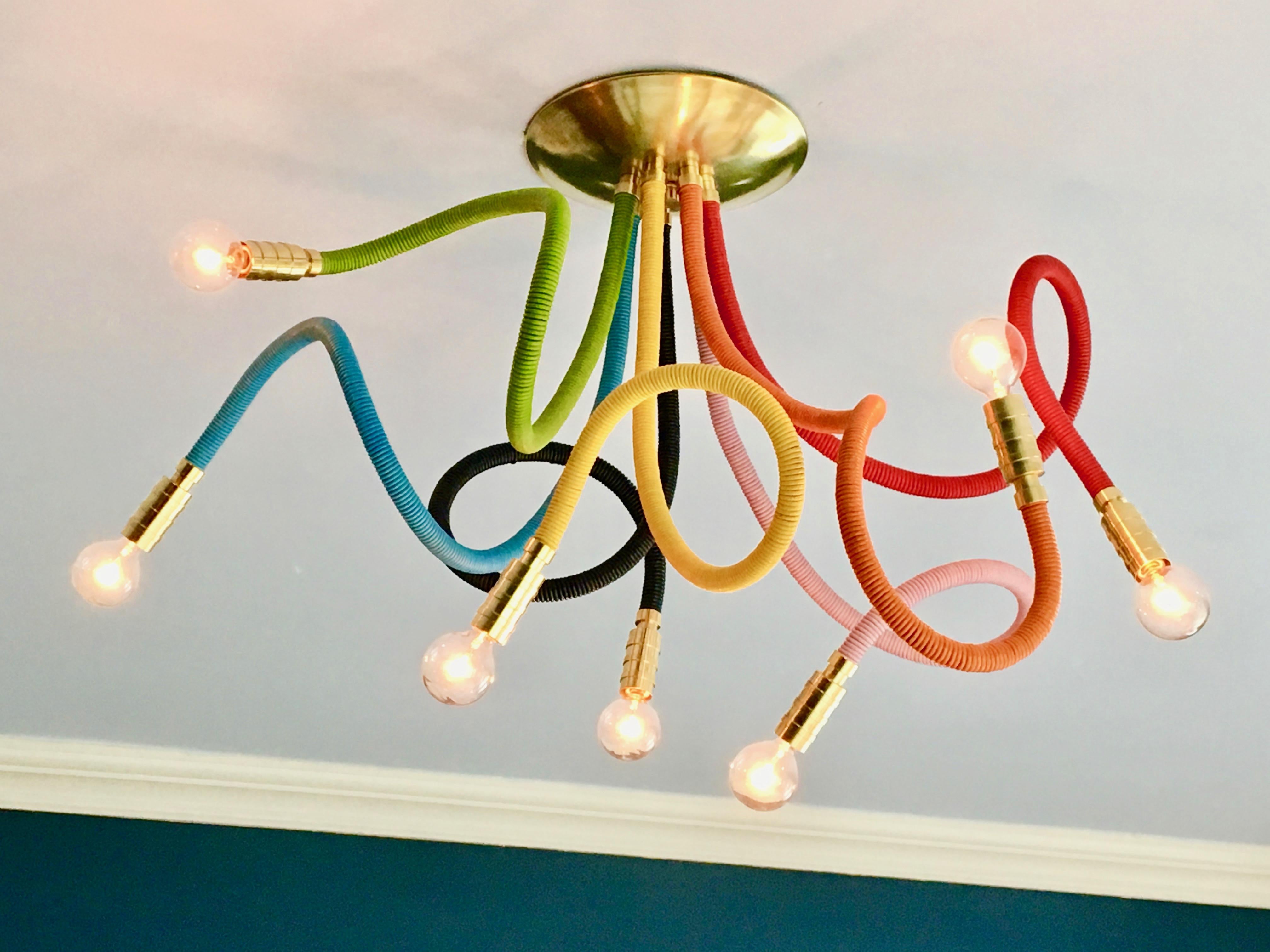 Our Meander Chandelier in glorious ROYGBIV colors. Seven flexible leather wrapped arms allows for playful poses and creative customization. 
As shown or choose from 25 leather colors, standard metal finishes and other custom options.