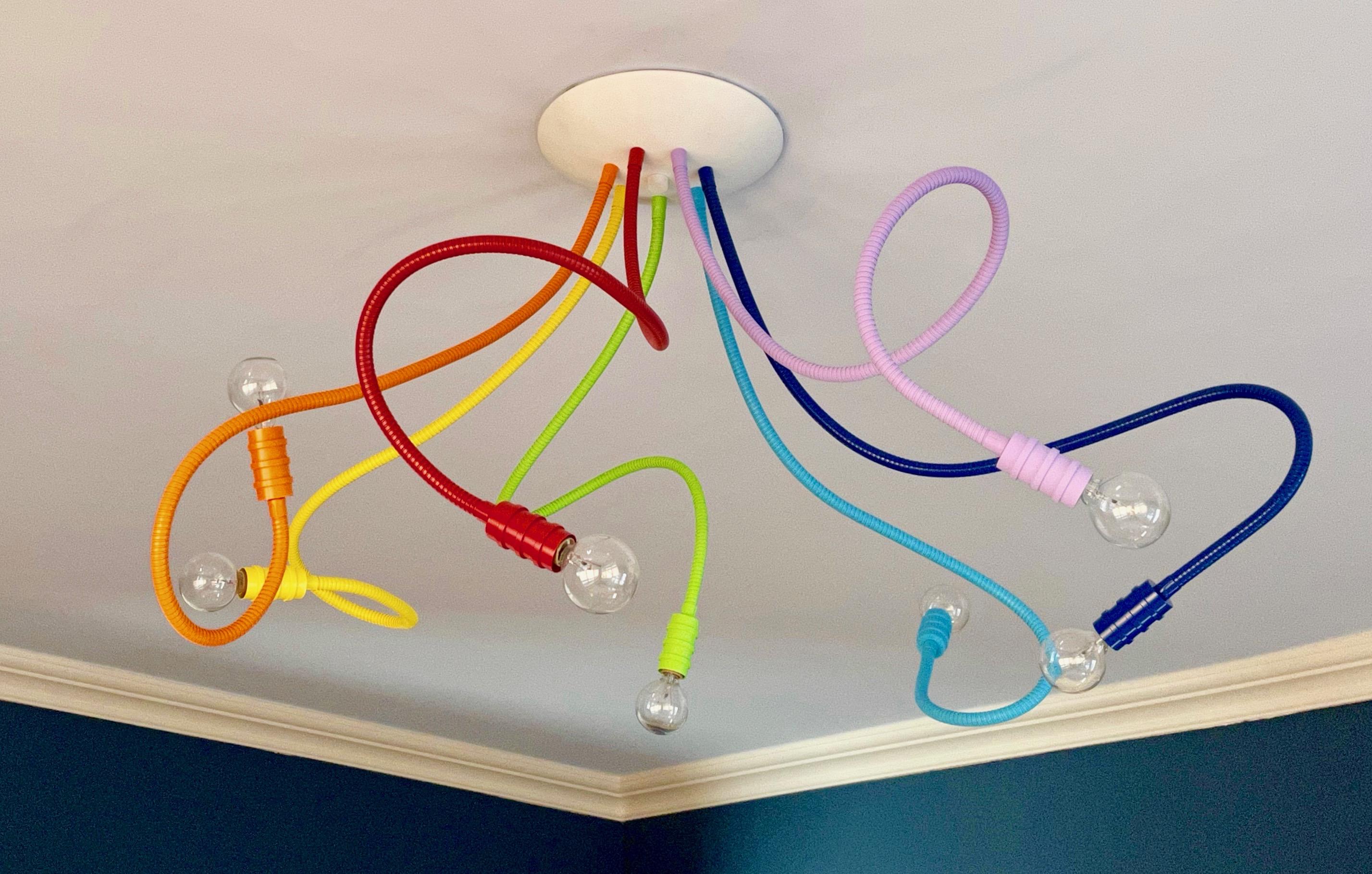 Be Flexible---with Meander lighting. Custom creative lighting with endless possibilities. 7 flexible metal arms allow for playful movement and unique designs. Shown here in joyous ROYGBIV colors.
Paying homage to vintage task lighting,