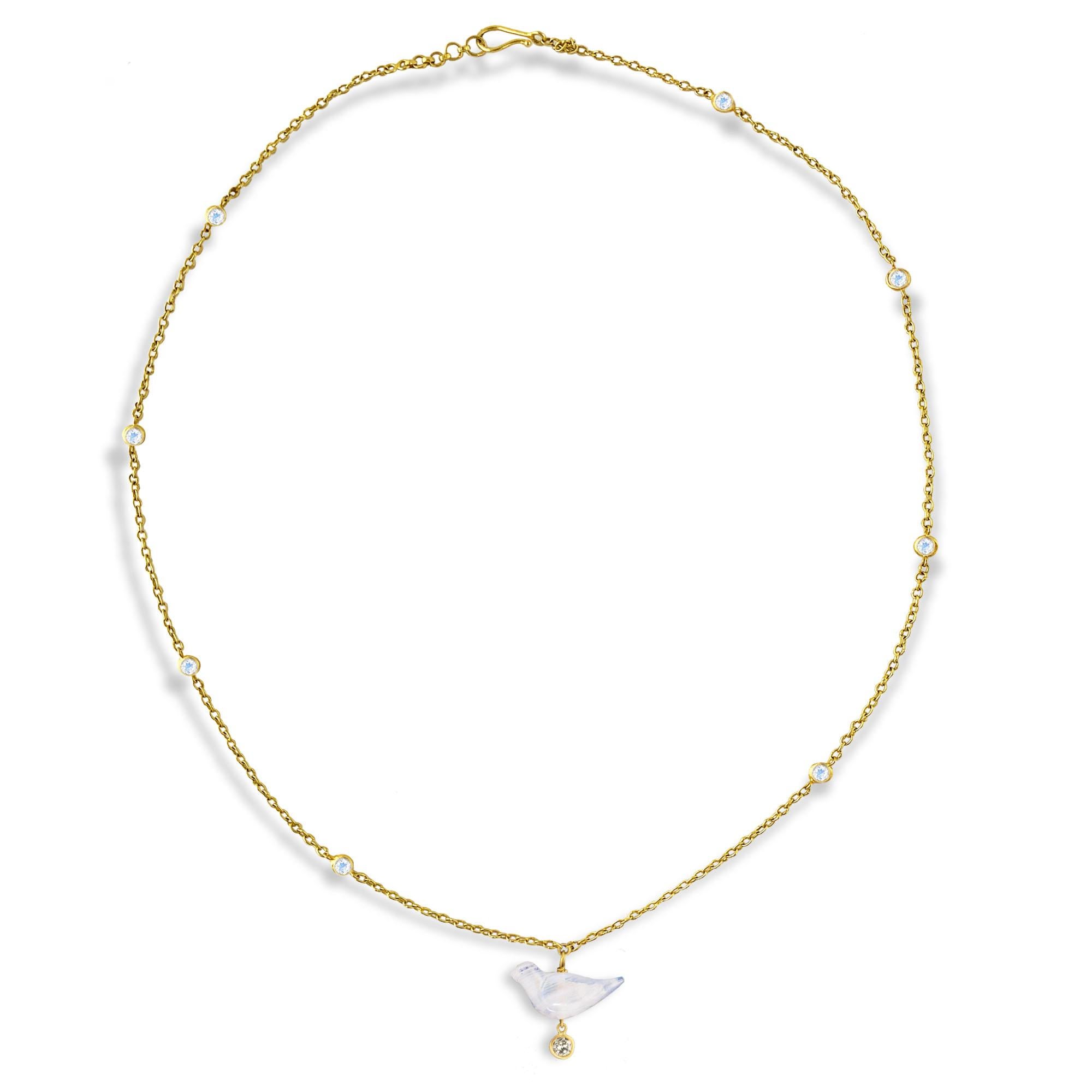Hand-carved Rainbow Moonstone bird with a diamond drop (.13 carats) is featured on a chain with rainbow moonstone accents. The necklace is finished with a hook closure. Wear this piece alone or layered with other favorite necklaces.  This piece is