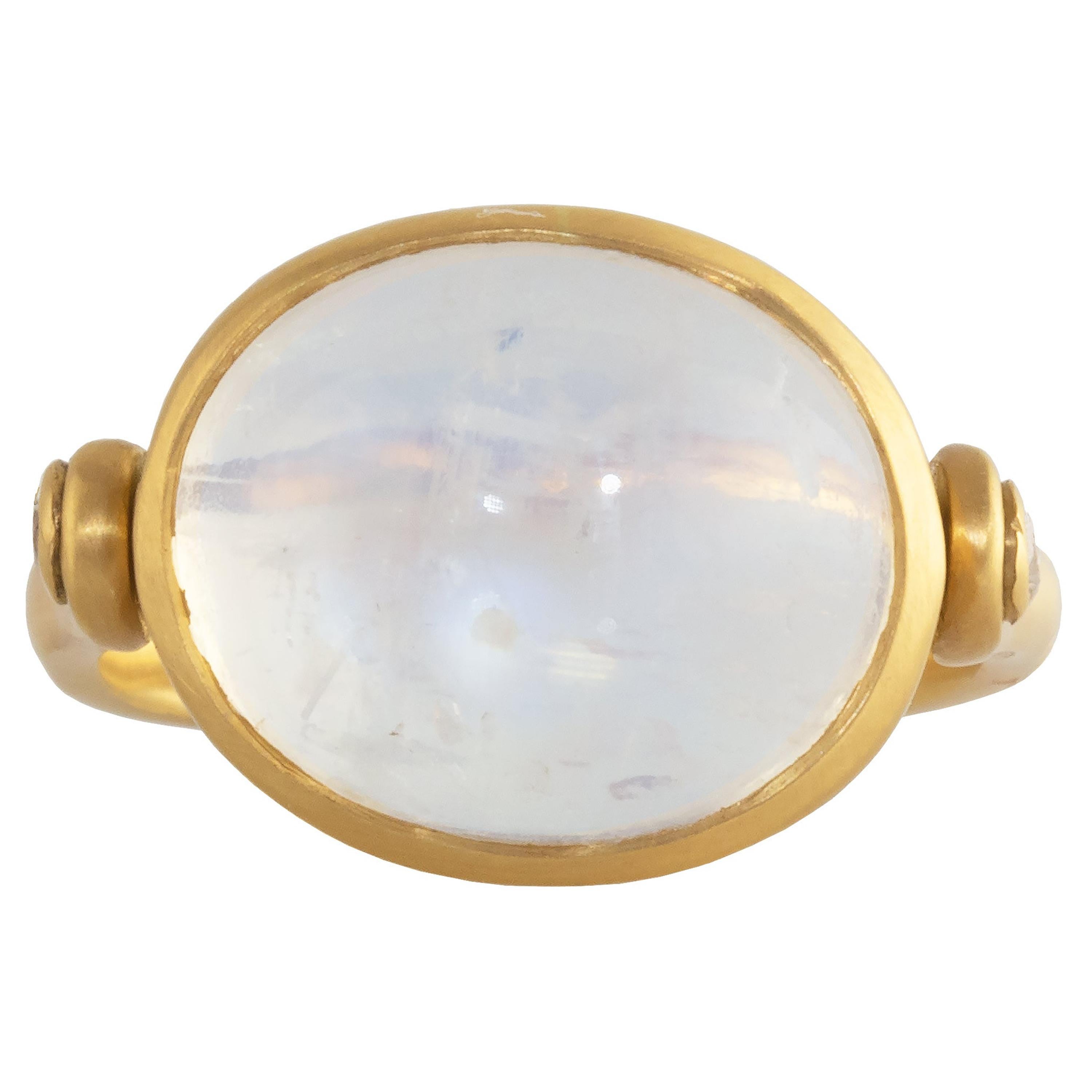 This one-of-a-kind swivel ring features a 11.46 carat Rainbow Moonstone Cabochon and diamond accents and is set in 18k matte yellow gold.  An  eye-catching piece. The ring has a satin finish with a polished center. Two white VS diamonds weighing