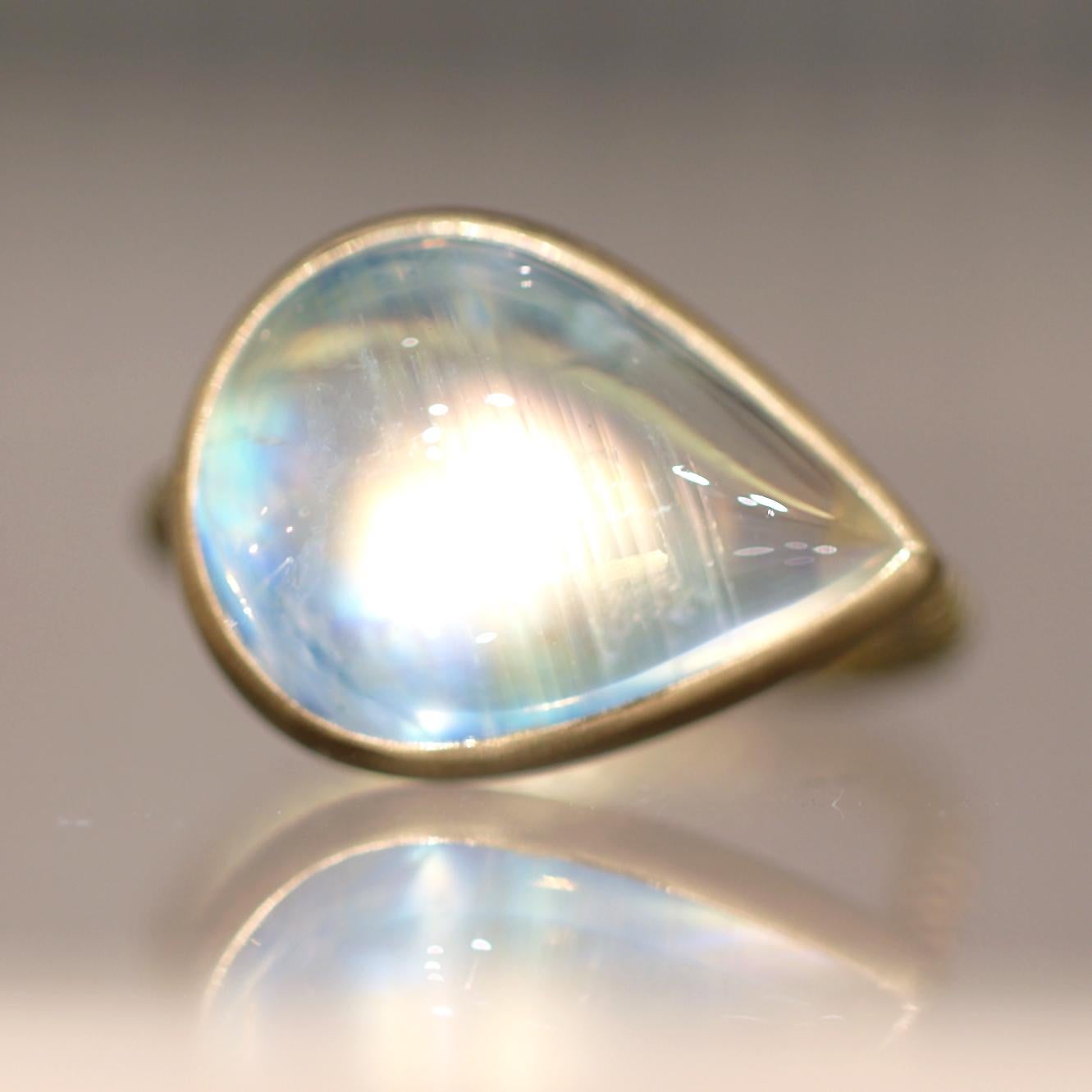 One of a Kind Editions Ring hand-fabricated in Japan by Talkative Marotta featuring a magical, ethereal 9.48 carat near-transparent rainbow moonstone cabochon with exceptional depth and adularescence, bezel-set in satin-finished 22k yellow gold atop