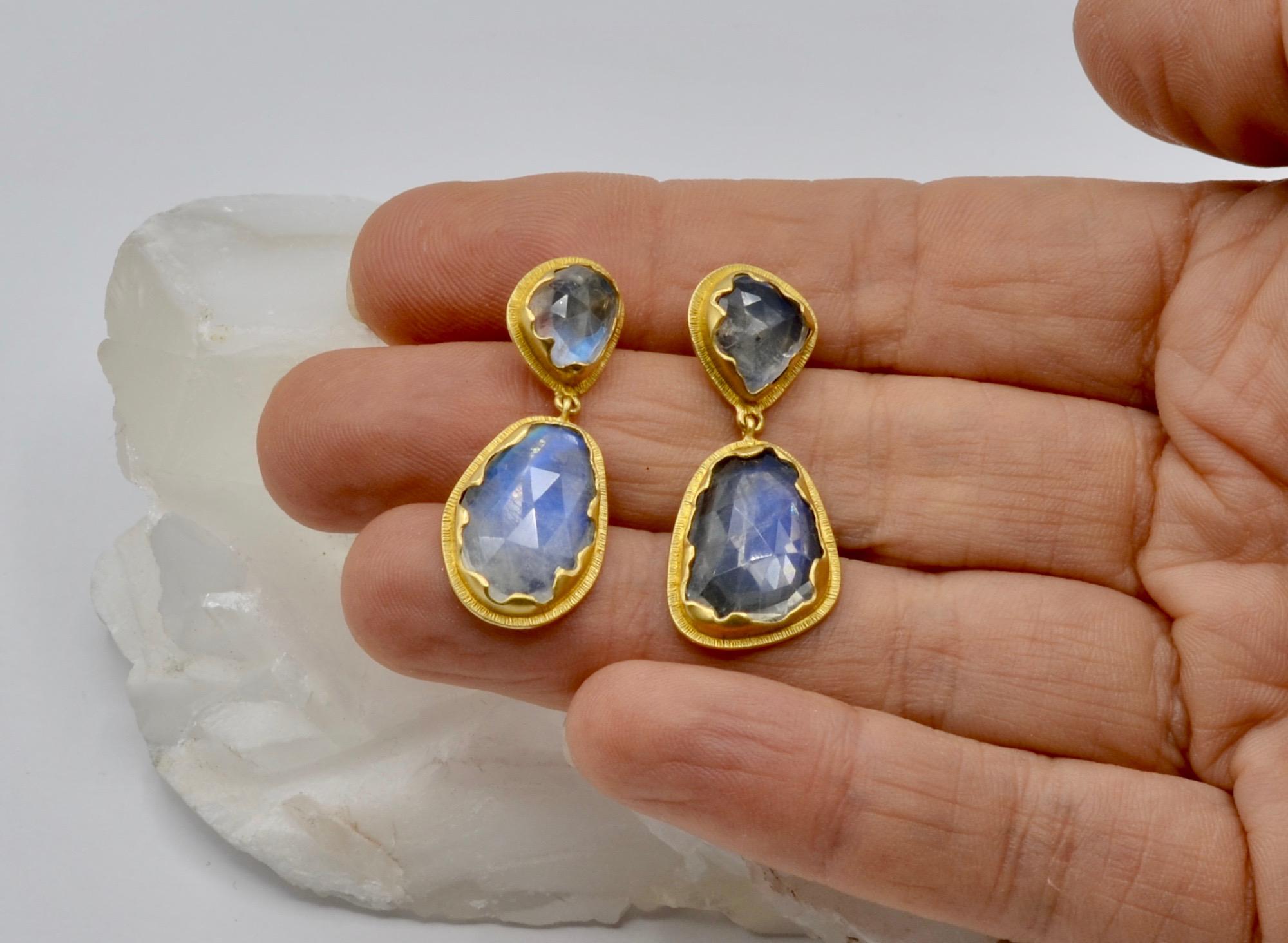 These mesmerizing Steven Battelle designed rose cut 15 carat total weight moonstones are set in a' torn paper' edge 18 karat gold setting .The moonstones are full of multicolor rainbows that catch the light on the rose cut surface. These are