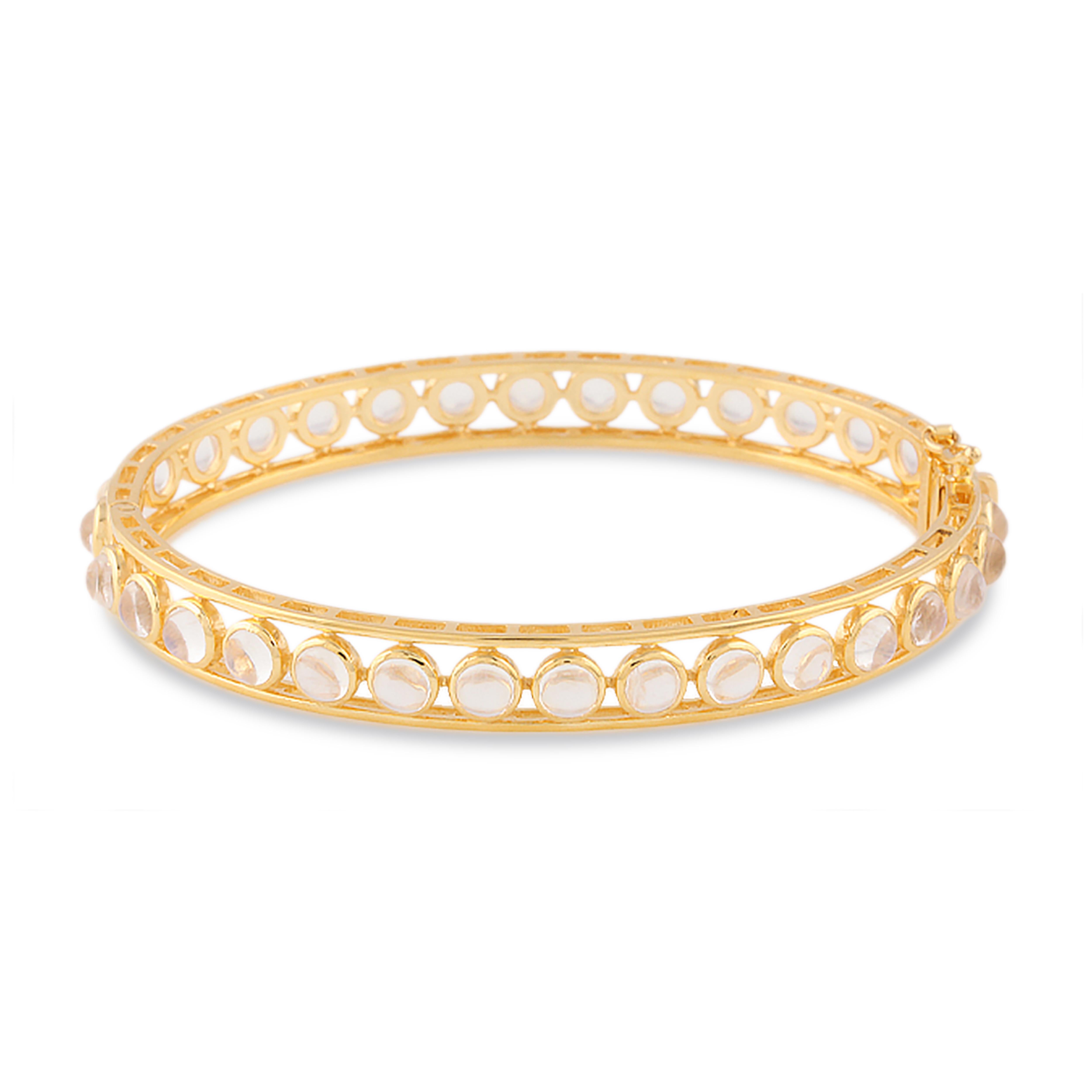 Tresor Rainbow Moonstone Bangle features 8.00 cts Rainbow Moonstone in 18k yellow gold. The Bracelet are an ode to the luxurious yet classic beauty with sparkly diamonds. Their contemporary and modern design makes them versatile in their use. The