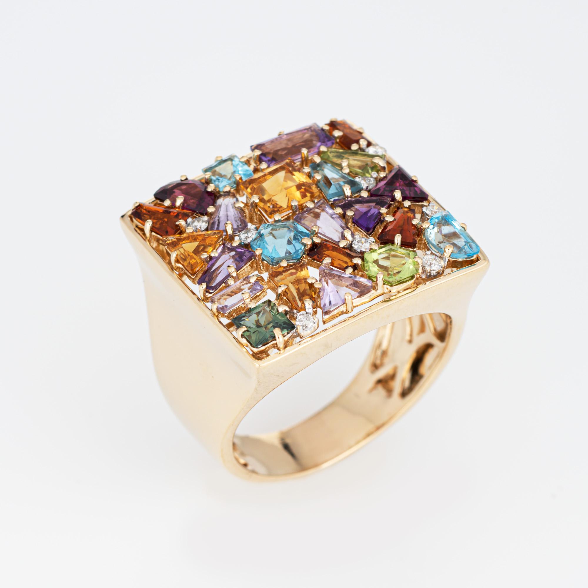 Stylish rainbow mosaic ring crafted in 14 karat yellow gold. 

Citrine, amethyst, peridot, and blue topaz in various shapes are set into the mount. 8 diamonds total an estimated 0.04 carats (estimated at H-I color and VS2-SI2 clarity). The stones