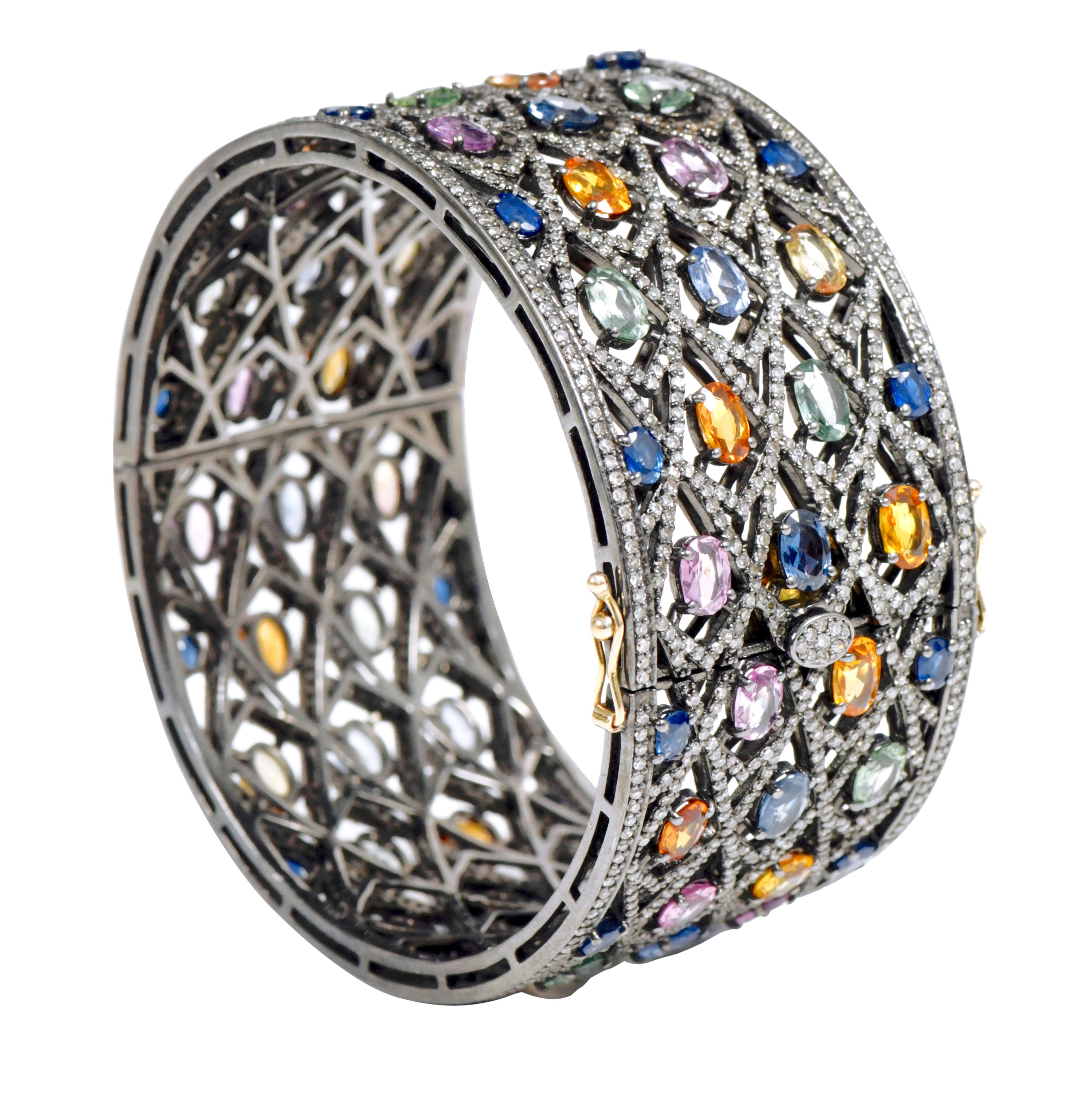 Rainbow Multi-Sapphire and Diamond Bangle in Art-Deco Victorian Style

A modern reverie of colors, this multicolored bangle is a modern amalgamation of heritage and excellent craftsmanship. Featuring a criss-cross design encrusted with diamonds,