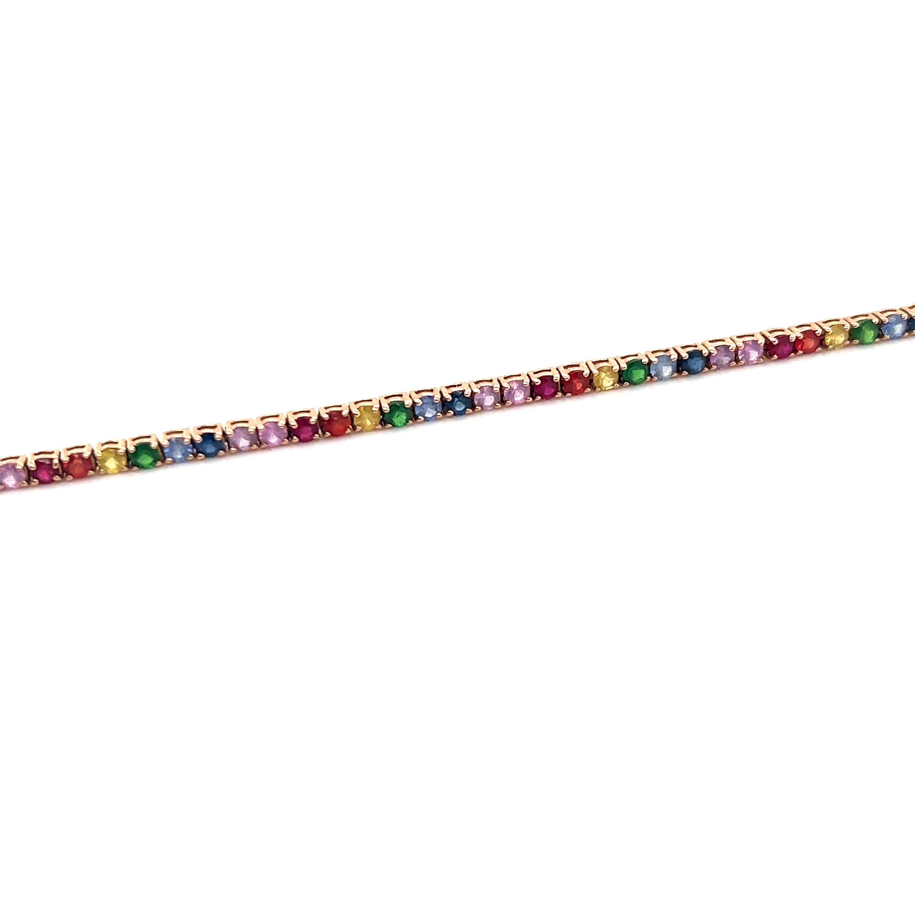 Trendy design seen on this modern bracelet crafted in 14k rose gold.  Sapphires come in a variety of different colors and this bracelet is a true showcase of mother natures beauty. The bracelet displays shades of blue, green, red and purple in a