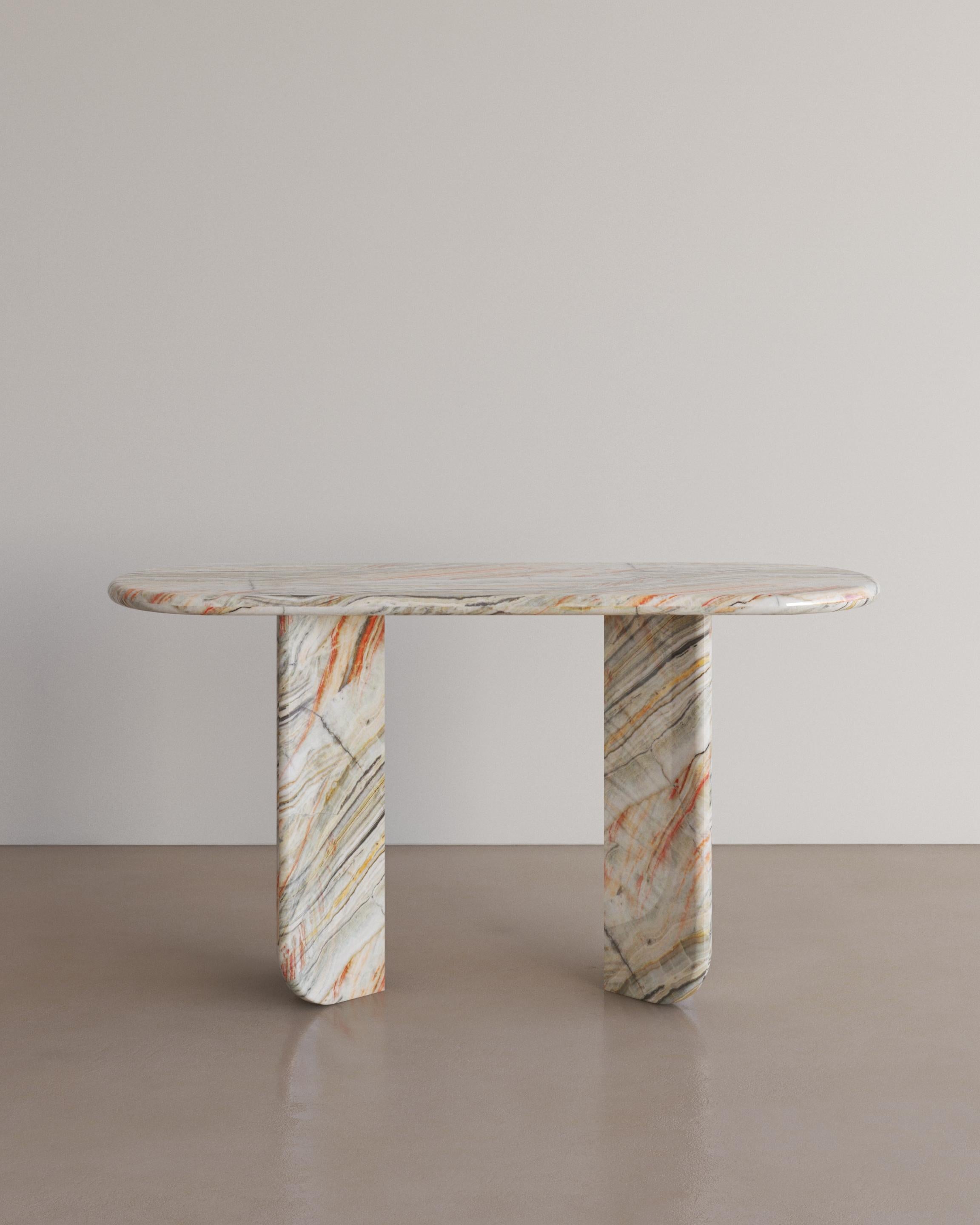 The Essentialist presents the Ètoile Console Table in Rainbow Onyx. An elongated oval stacks upon 2 chevron bases. Smooth planes exonerate beautiful natural patterning, poised between transience and permanence, between form and the absence of form.