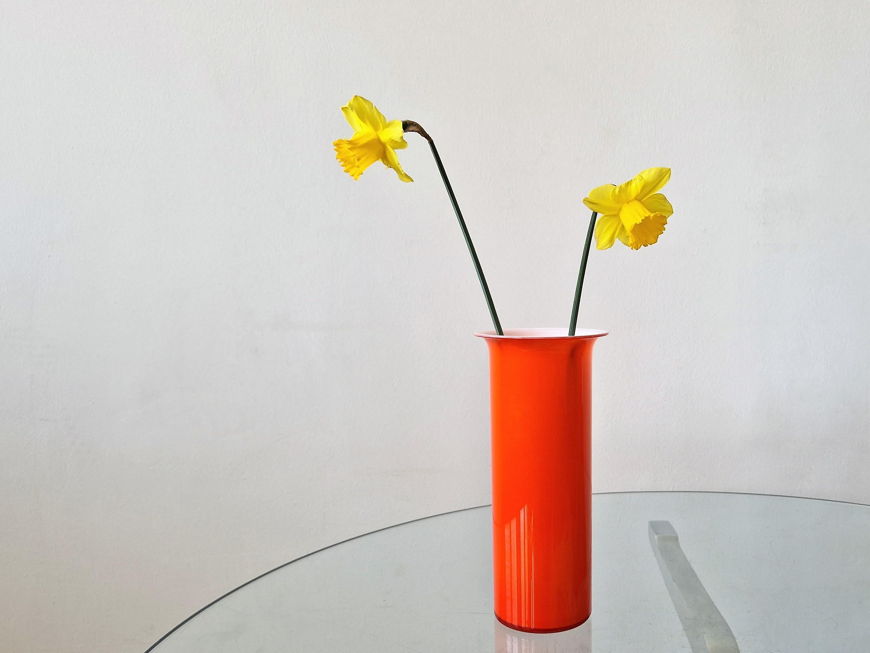 This is a stunning orange glass Holmegaard vase with white inner casting, designed by Michael Bang. It is part of his 'Regnbue' (Rainbow) range. The vase is in a very good condition, with minor signs of age and use.
