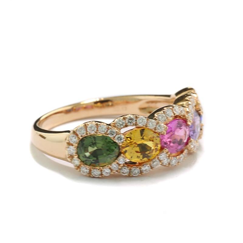 Rainbow Ring with five sapphires in five different colors (green, yellow, pink, purple, blue), approx. 2.13 carats in total, oval cut. The sapphires are surrounded by 54 brilliant-cut diamonds, approx.  0.33 carats in total, Color: H, Clarity: SI.