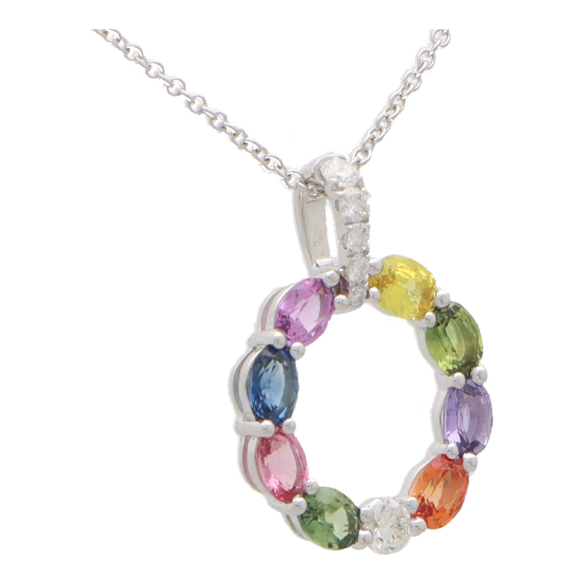 A stylish rainbow sapphire and diamond pendant necklace set in 18k white gold.

The pendant is composed in a white gold hoop and is set throughout with oval cut rainbow sapphires; all of which perfectly complement each other. The hoop elegantly