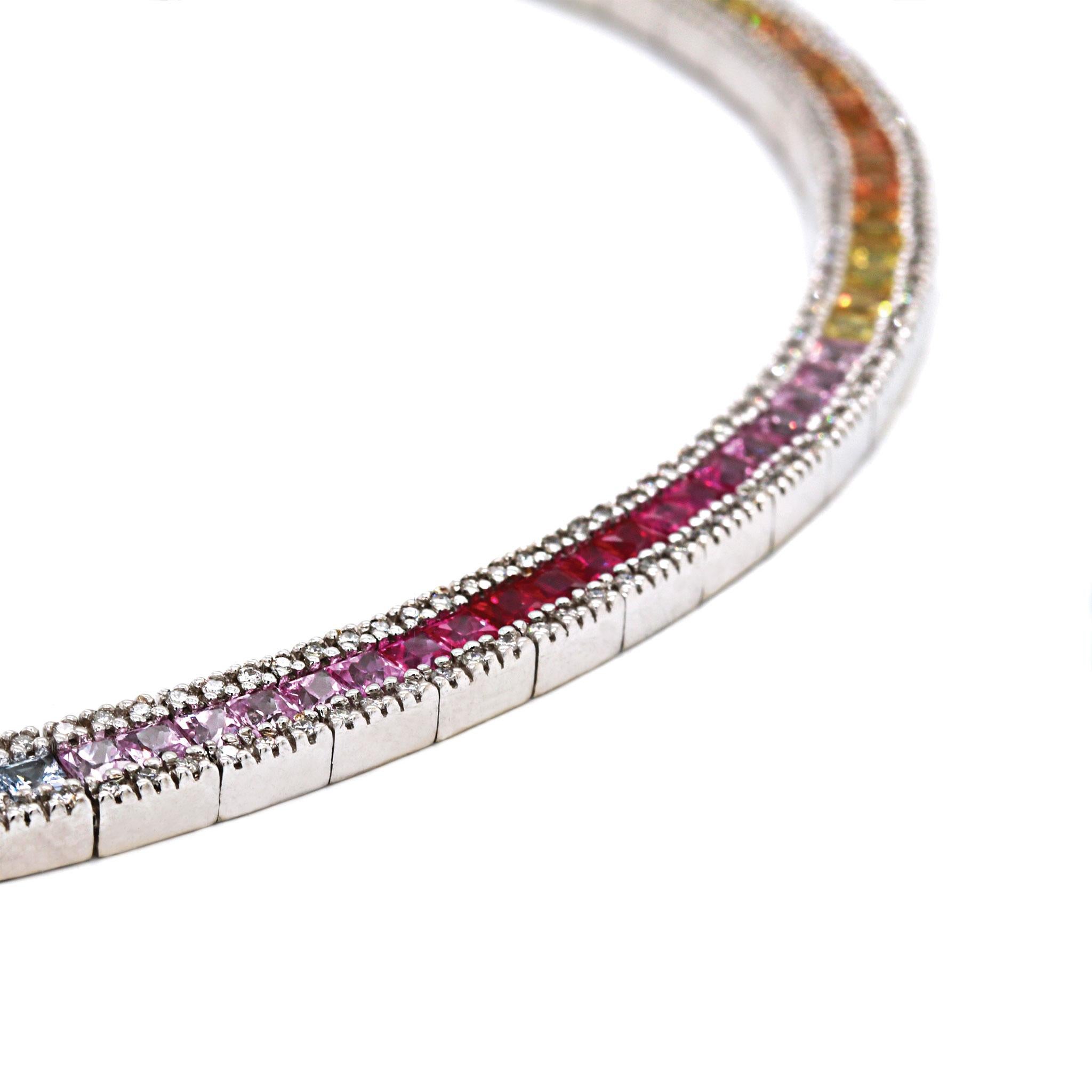 A uniquely luxurious rainbow sapphire link necklace with diamond and gold accents. The solid 14K white gold chain features 8.42ctw of gradient multi-colored gemstones displaying the spectrum of natural sapphire hues. Featuring 1.22ctw of H-I/SI1-2